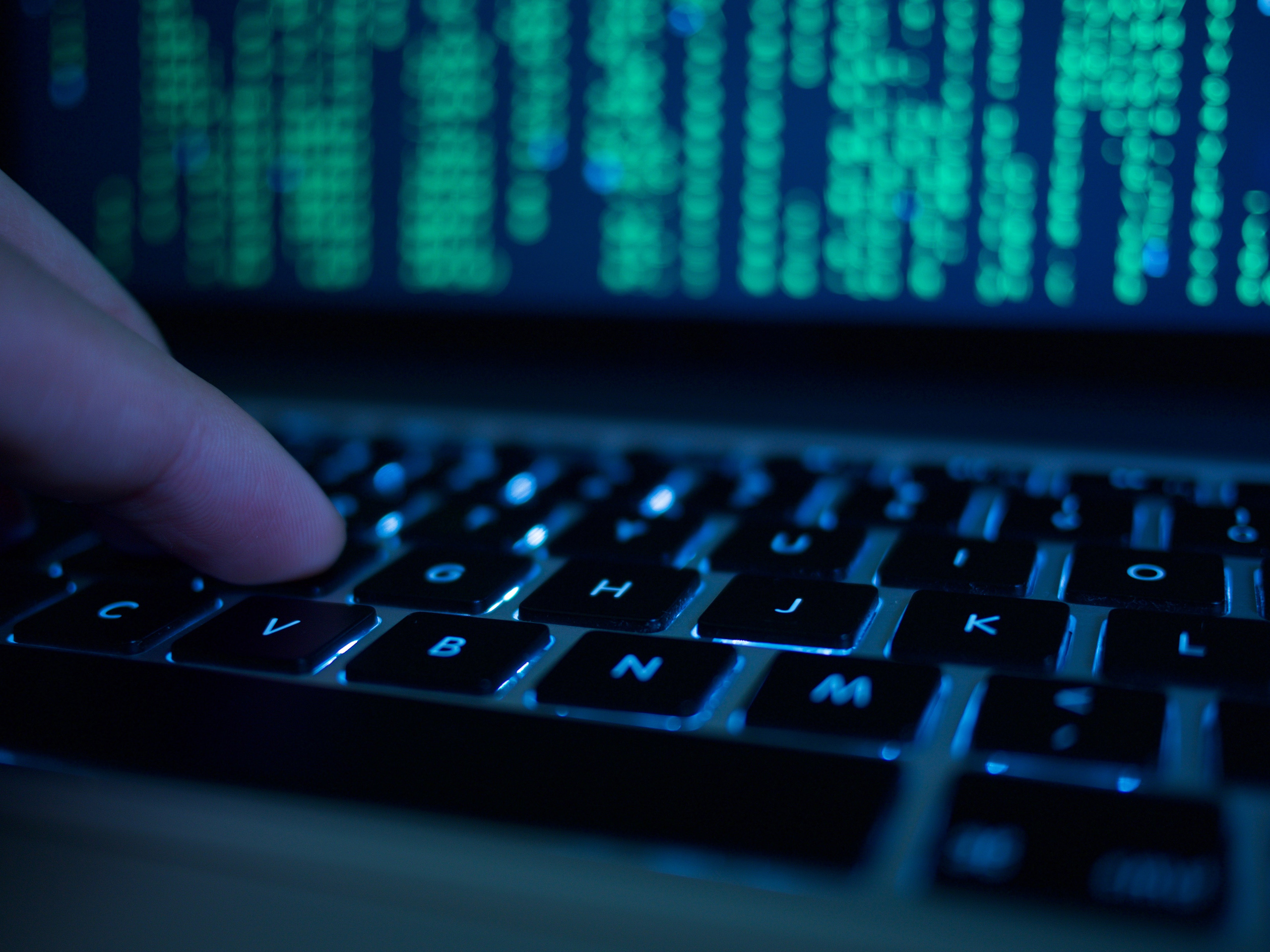 Cropped Hand Of Computer Hacker Typing On Keyboard