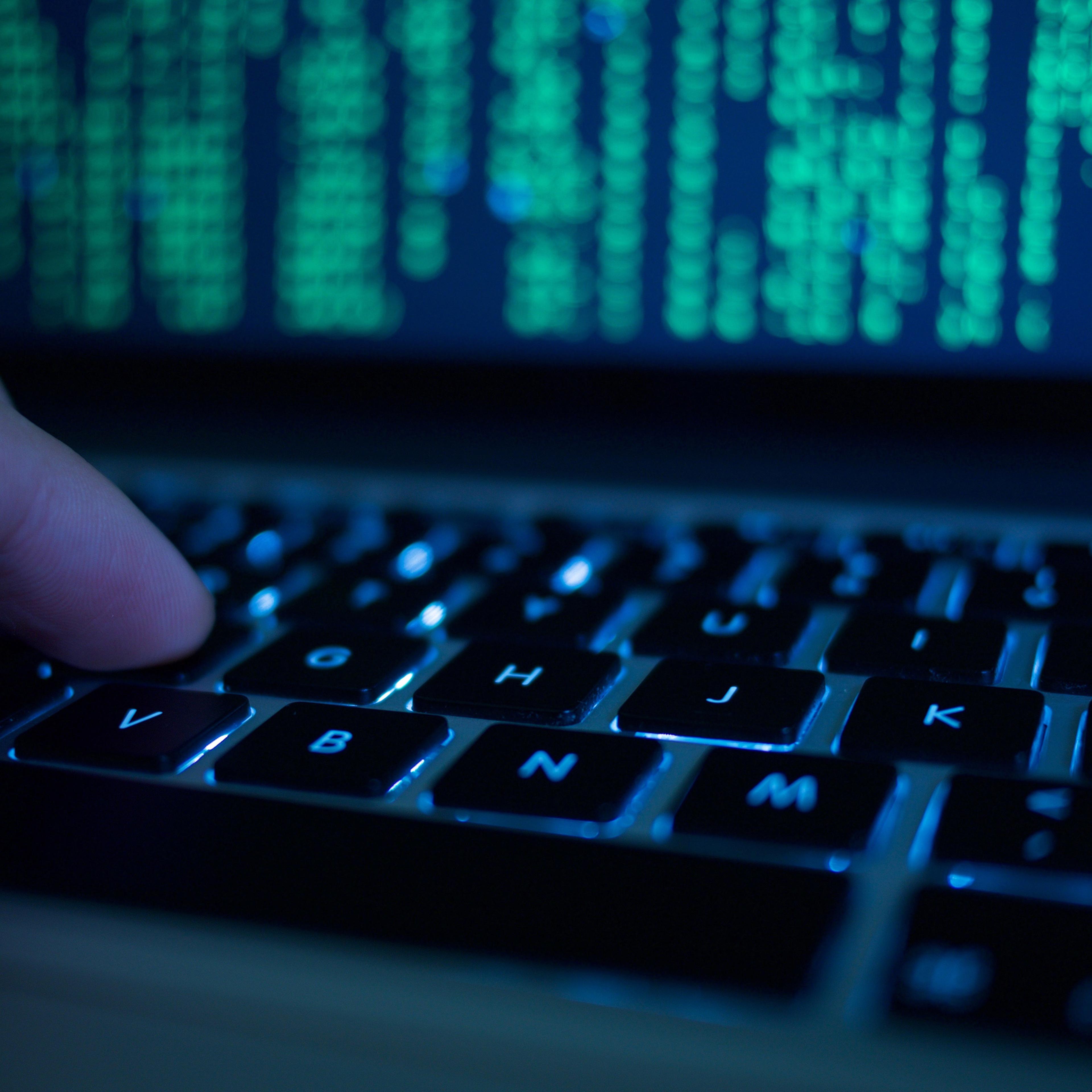 Cropped Hand Of Computer Hacker Typing On Keyboard