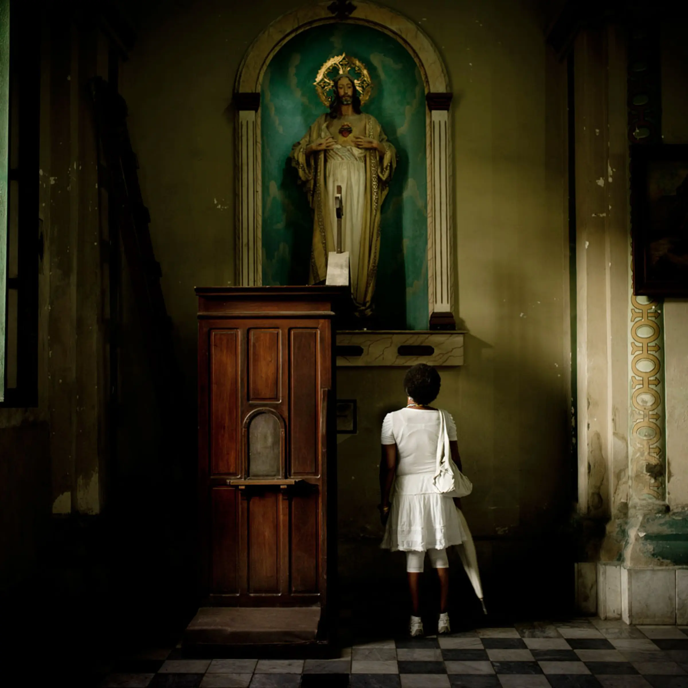 March 19, 2012. A woman, who practices Santería prays at the Cathedral of Santiago de Cuba.