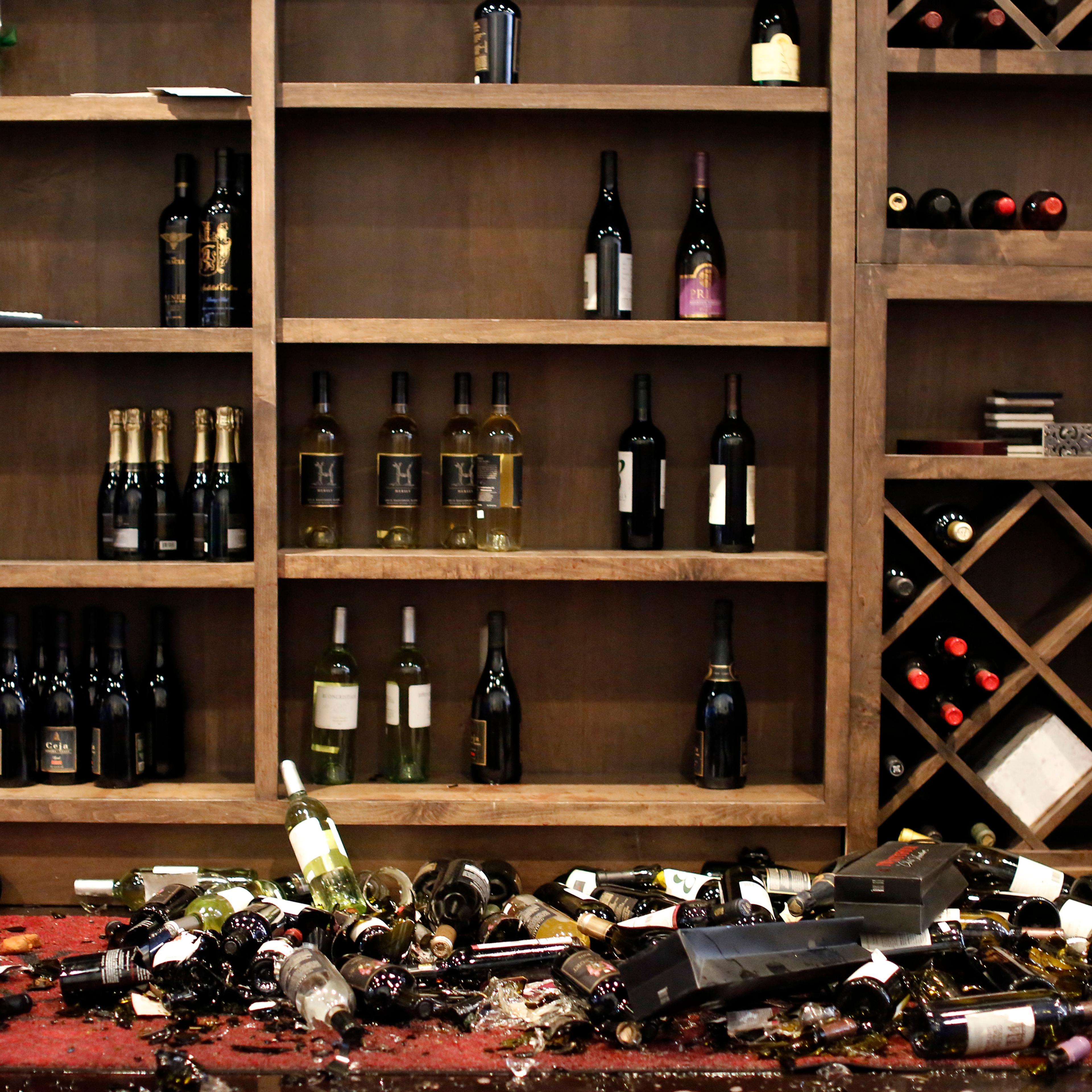 Fallen wine bottles are seen at Cult Following Wine Bar after an earthquake in Napa, California