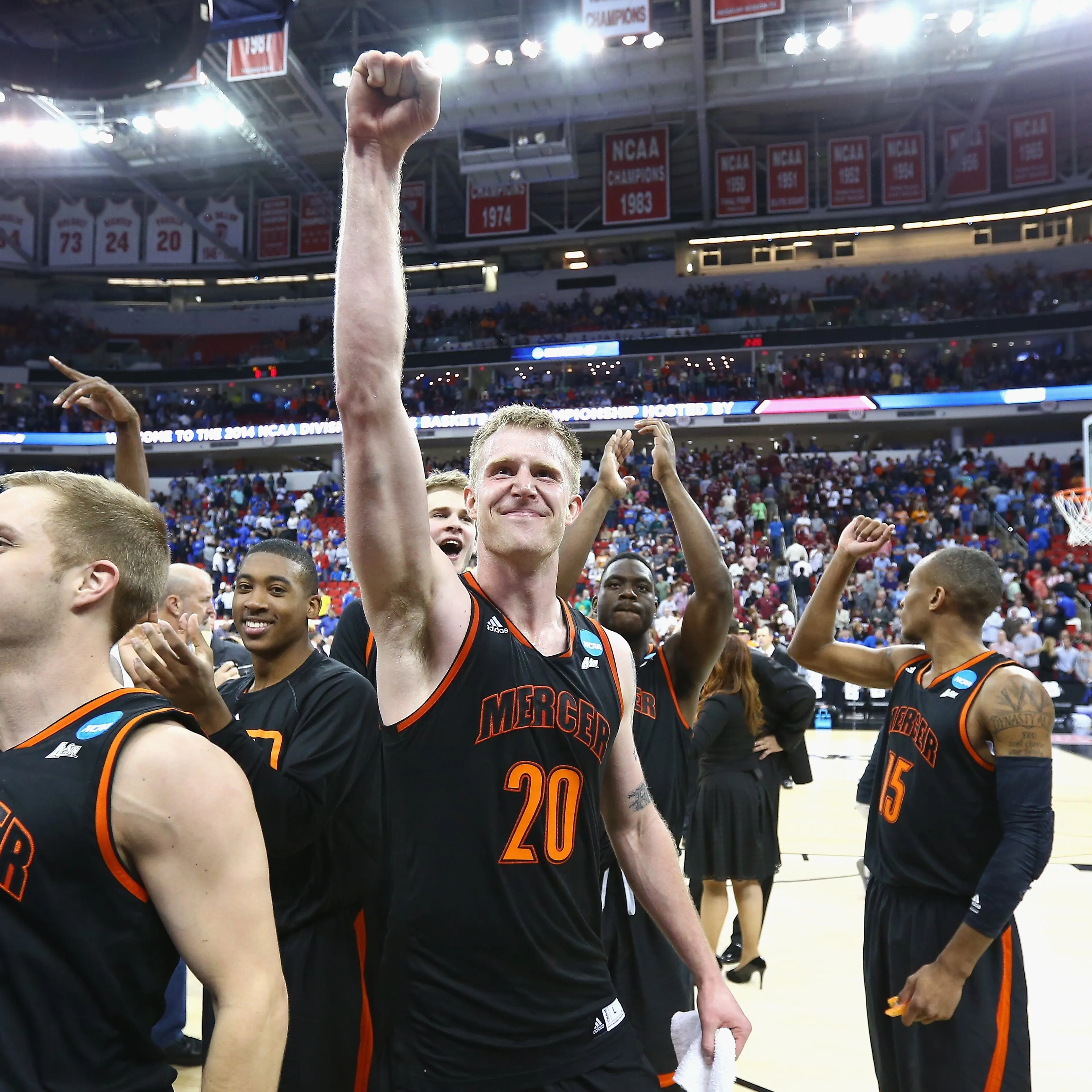 Jakob Gollon of the Mercer Bears celebrates with teammates after defeating the Duke Blue Devils 78-71