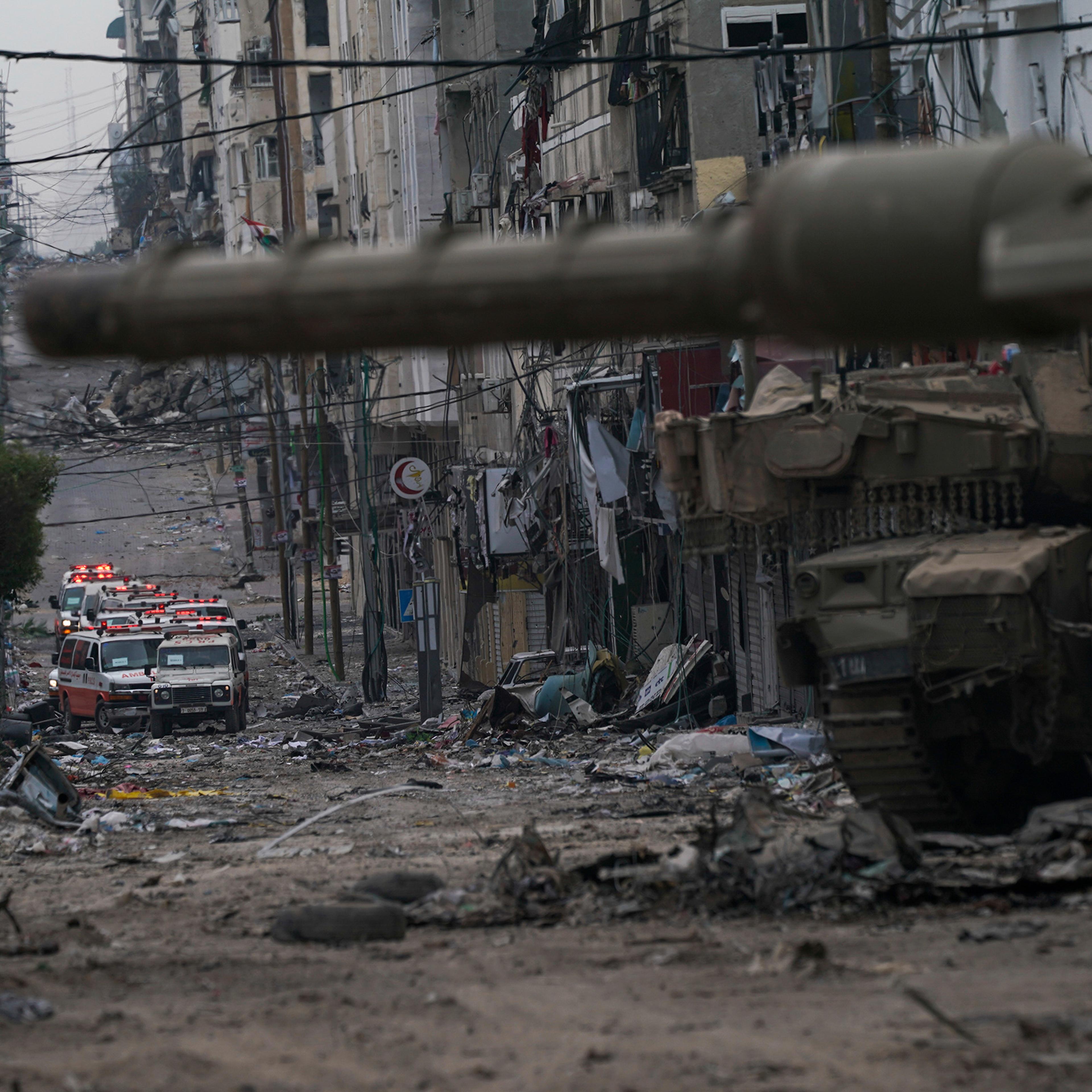 Ambulances are seen on a road near an Israeli forces tank during an Israeli army ground operation in the Gaza Strip on Nov. 22.