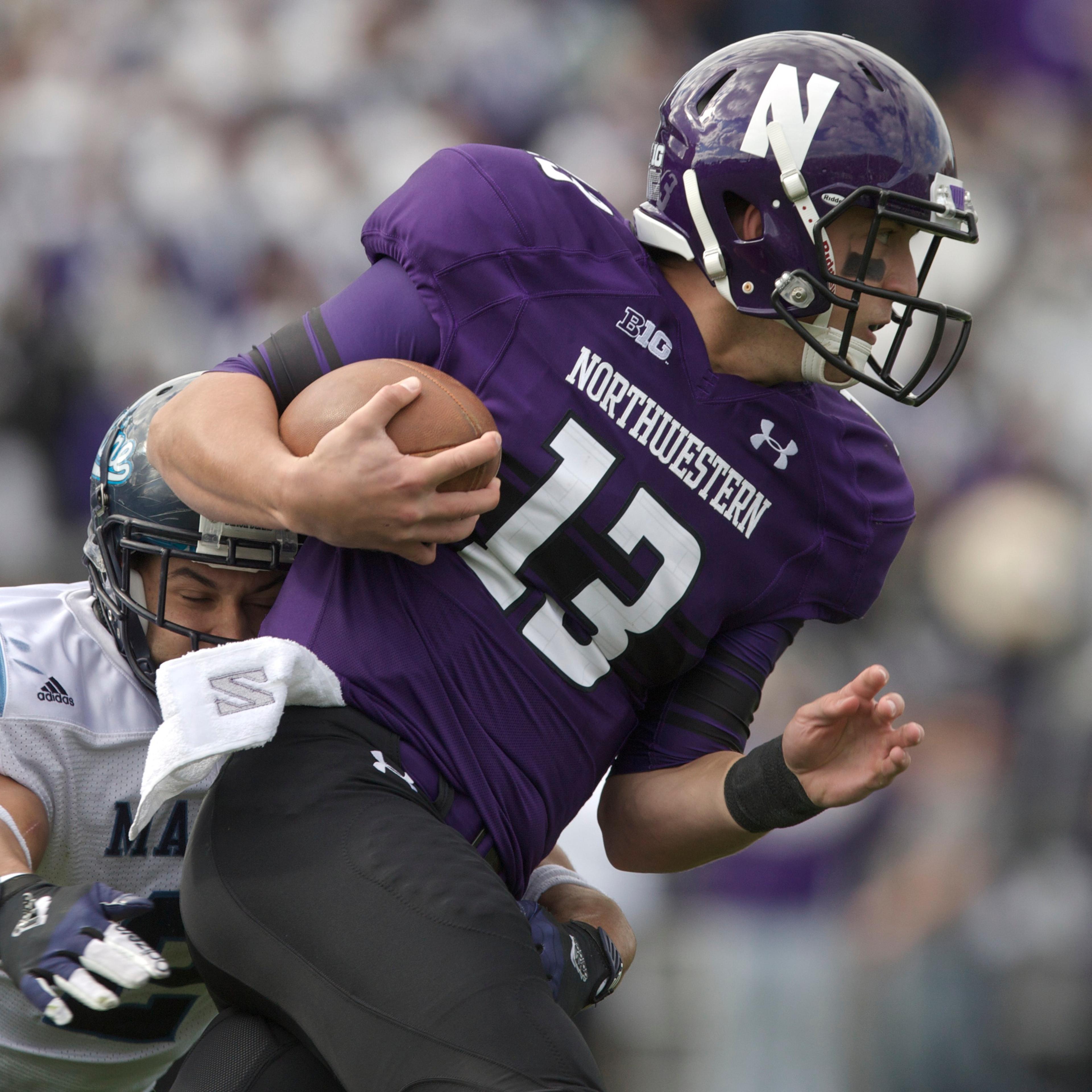 Cabrinni Goncalvesof the Maine Black Bears tackles Trevor Siemianof the Northwestern Wildcats during their college football game at Ryan Field on September 21, 2013 in Evanston, Illinois.