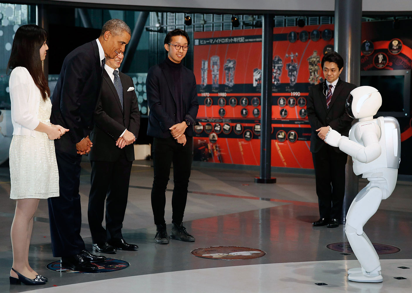 President Barack Obama bows to "Asimo" the robot while visiting Miraikan or the National Museum of Emerging Science and Innovation, in Tokyo, April 24, 2014.