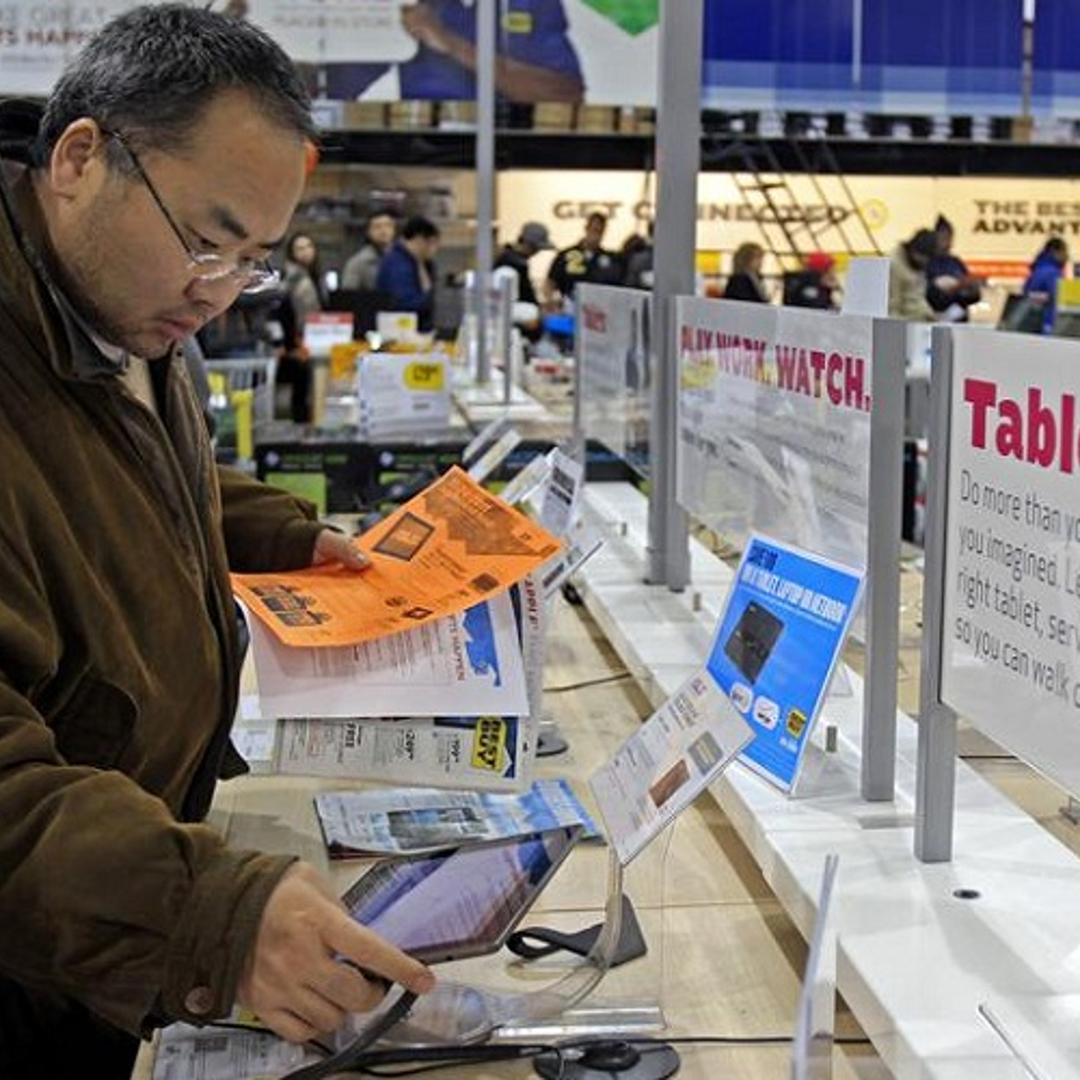 A shopper looks at tablet computers at a Best Buy Store on the shopping day dubbed "Black Friday" in Framingham