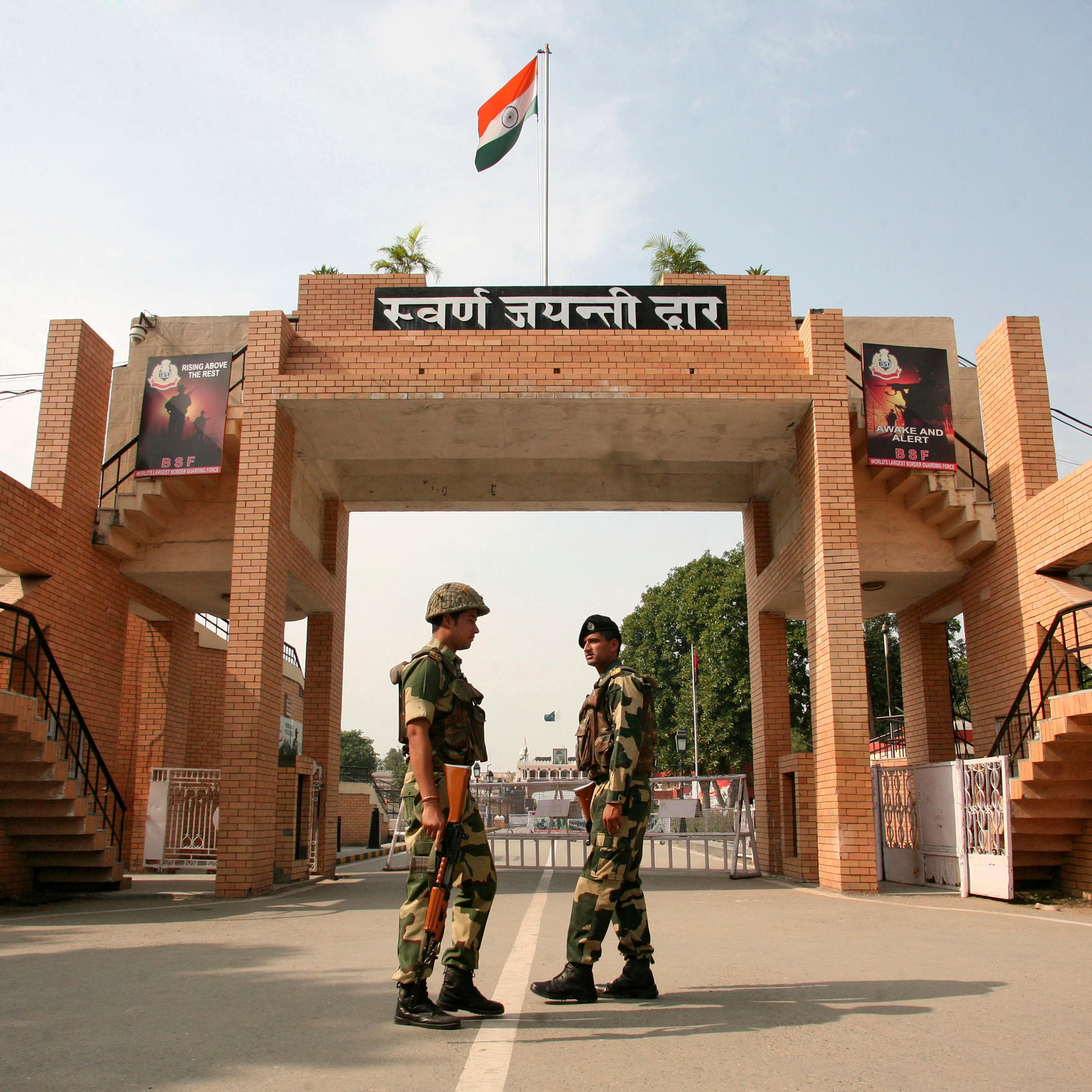 India's BSF soldiers patrol in front of the golden jubilee gate at the Wagah border