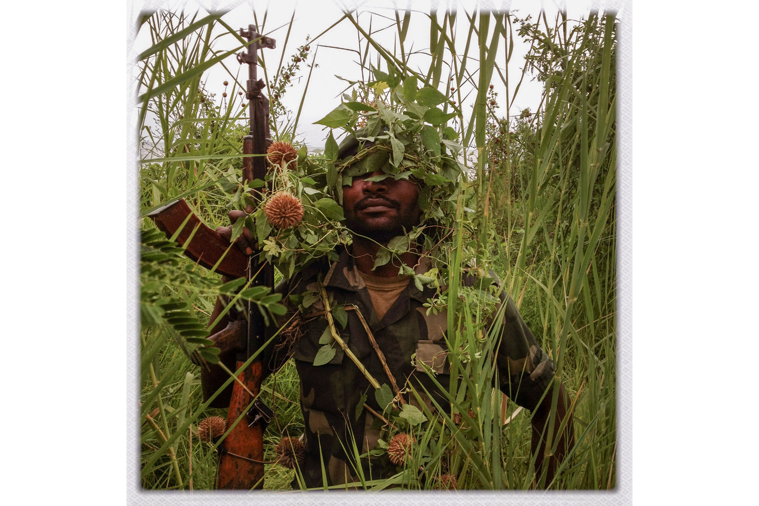 An FARDC soldier poses for a portrait by Lake Kivu.