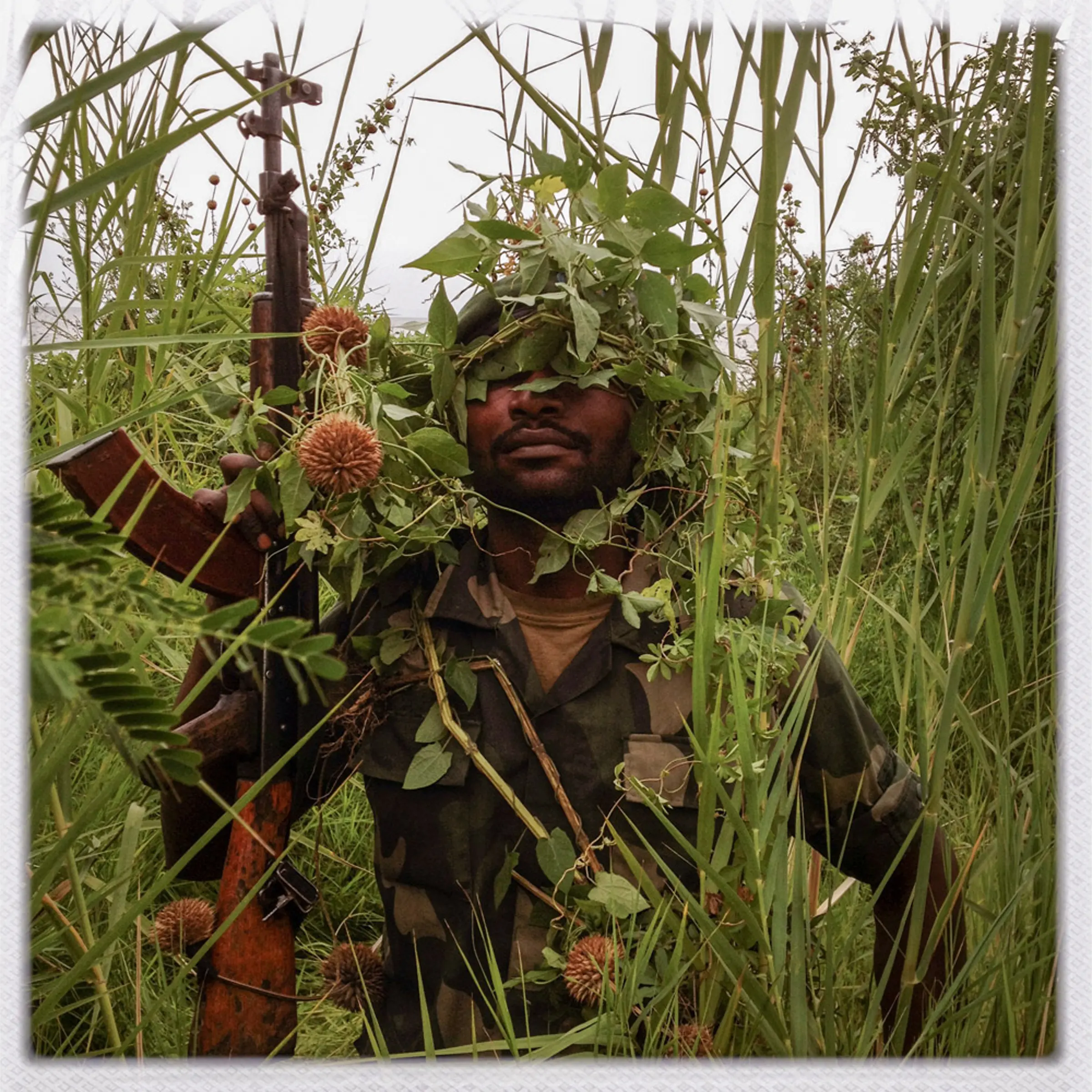 An FARDC soldier poses for a portrait by Lake Kivu.