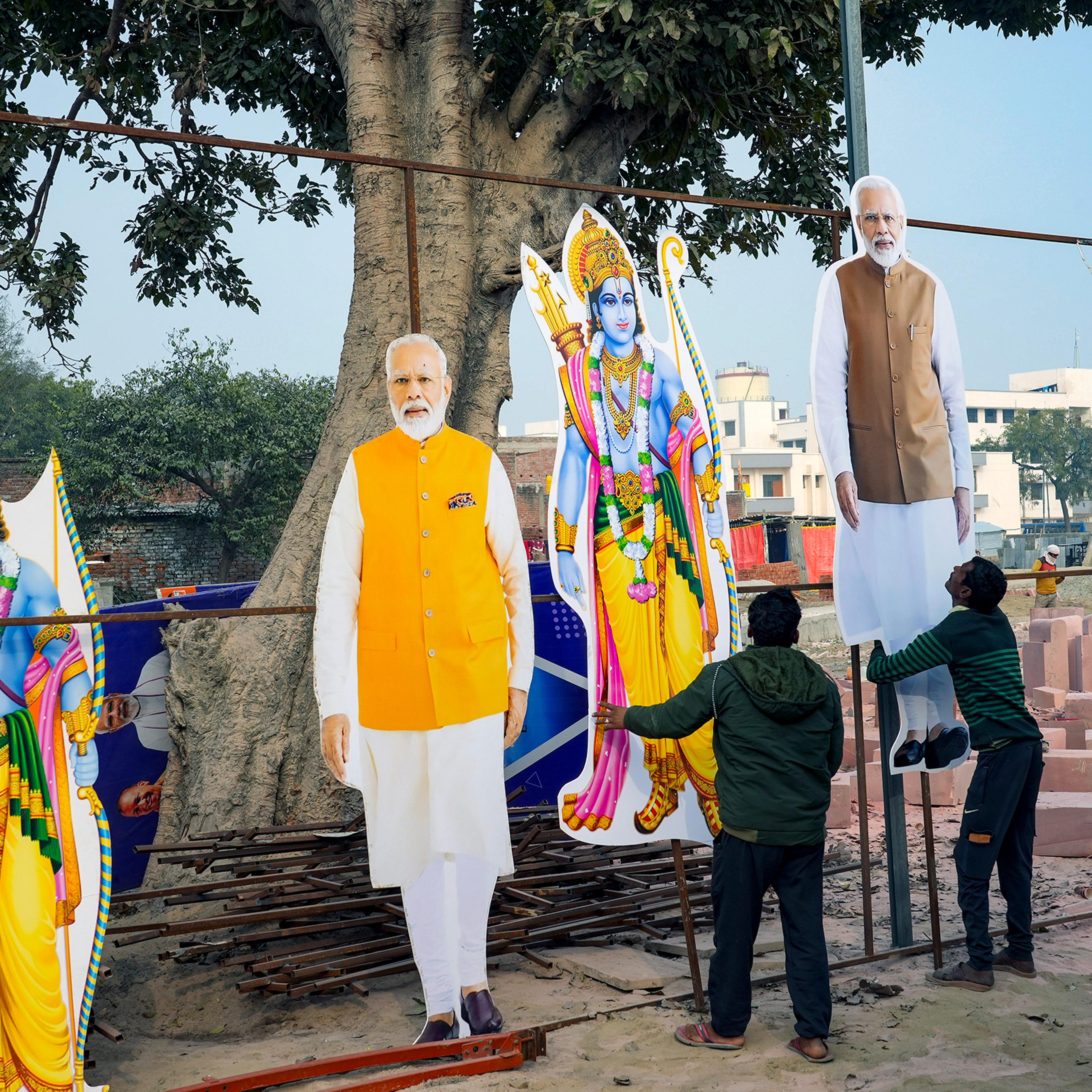 Workers put up cutouts of Hindu deity Lord Ram and Indian Prime Minister Narendra Modi in Ayodhya, India, on Jan. 18.