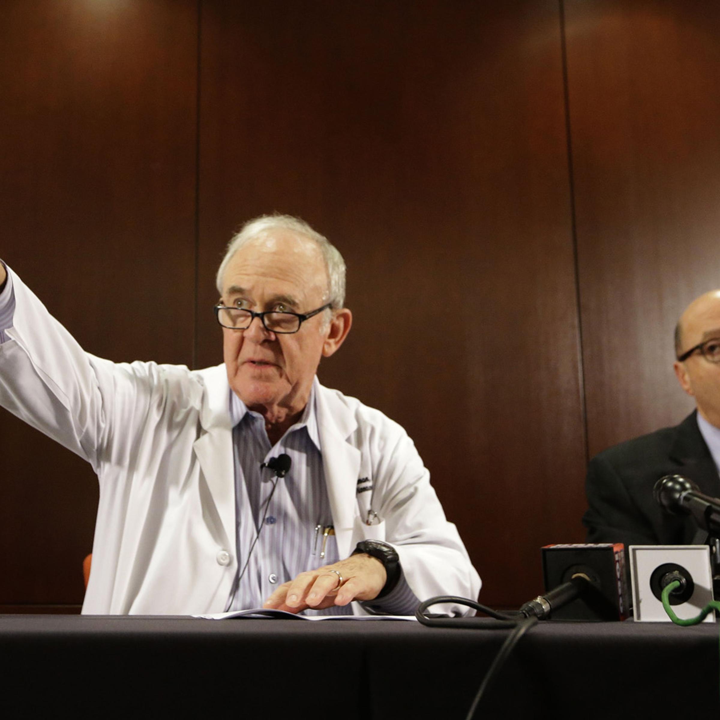 Dr. Edward Goodman, left, epidemiologist at Texas Health Presbyterian Hospital Dallas, points to a reporter for a question as Dr. Mark Lester looks on during a news conference about an Ebola infected patient they are caring for in Dallas, Sept. 30, 2014.