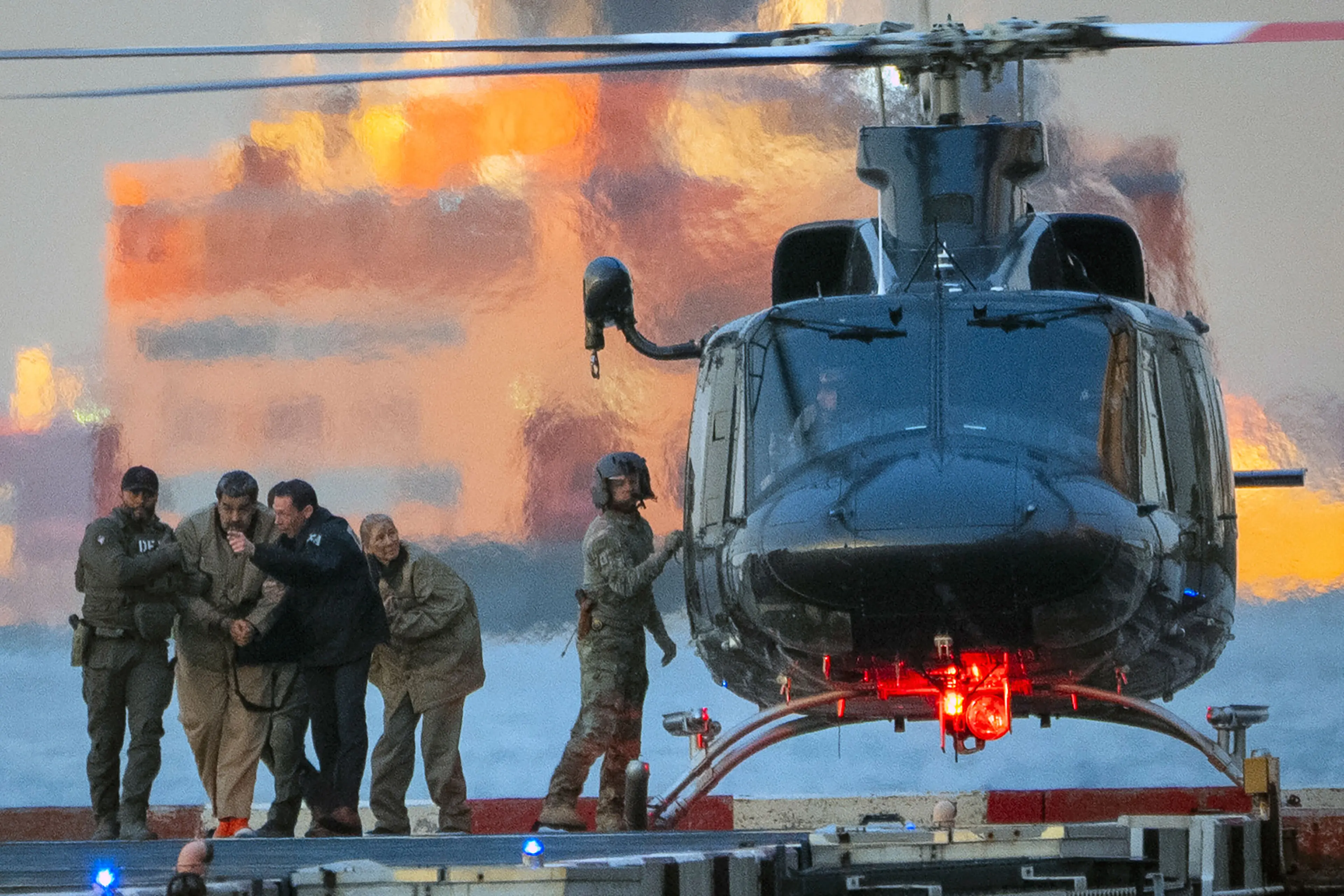 Nicolas Maduro, the ousted president of Venezuela, and his wife, Cilia Flores, are escorted off a helicopter en route to the federal courthouse in Manhattan on Monday morning, Jan. 5, 2026.