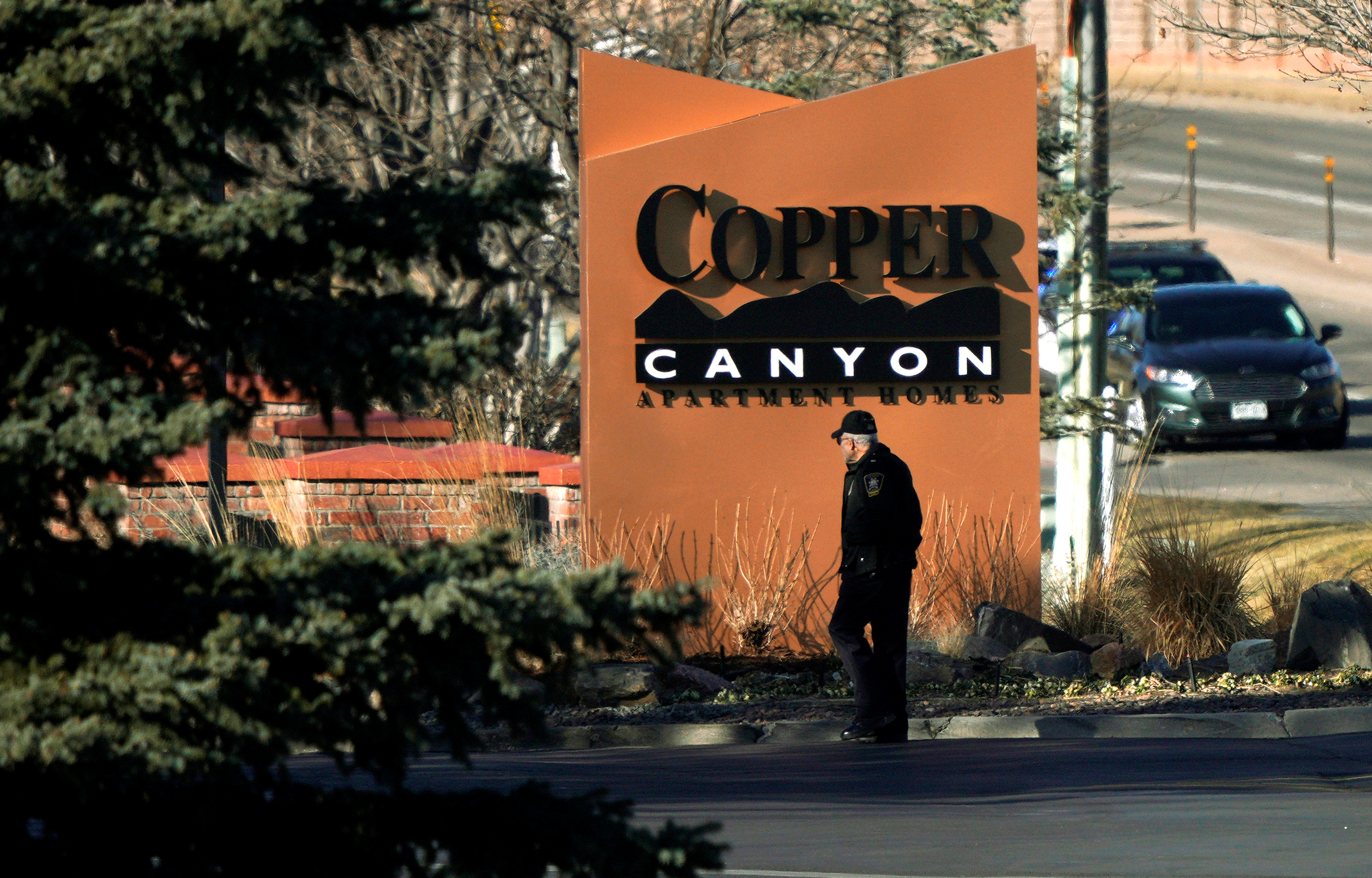 A police officer walks into the Copper Canyon apartments, the scene of the incident where deputies and civilians were shot in Highlands Ranch