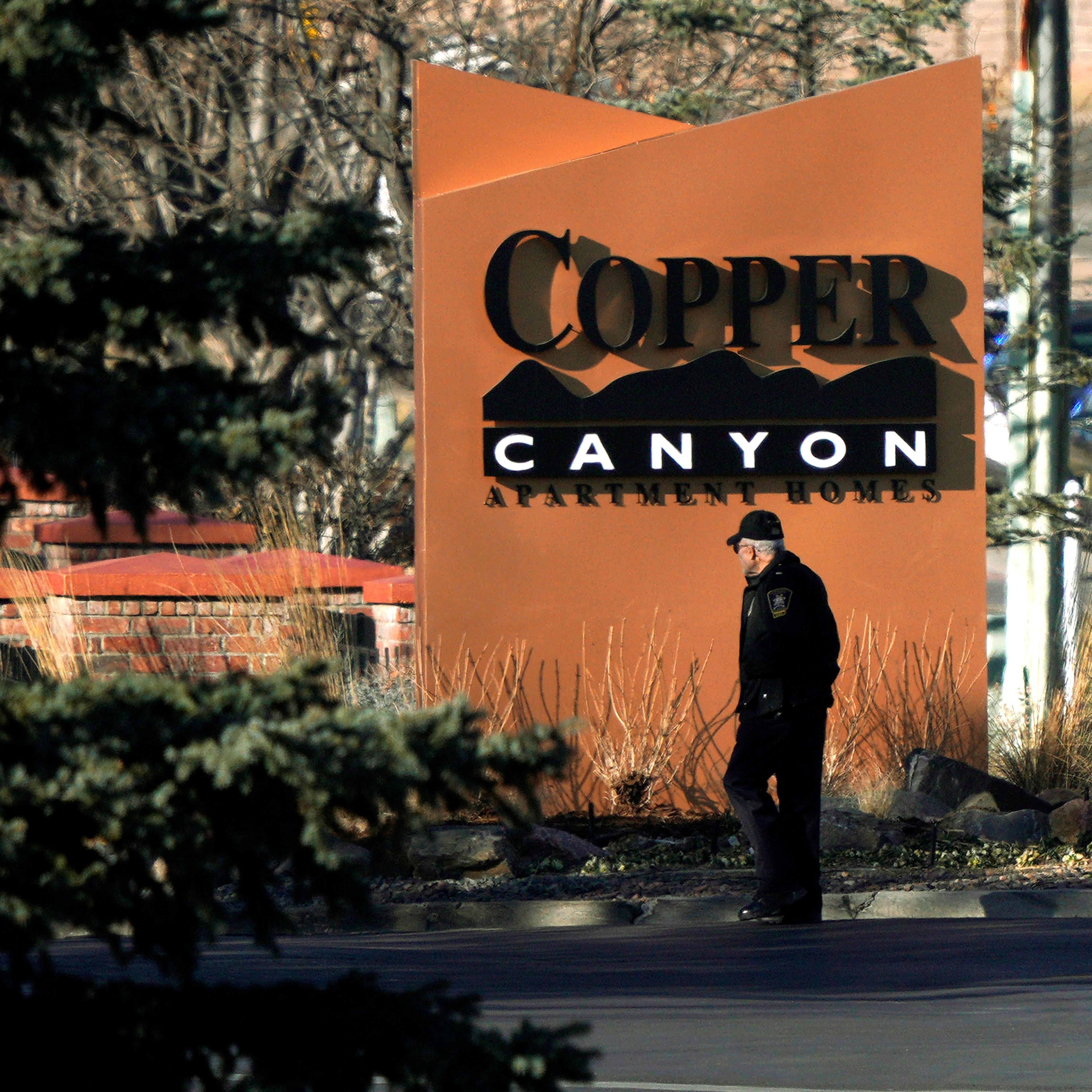 A police officer walks into the Copper Canyon apartments, the scene of the incident where deputies and civilians were shot in Highlands Ranch