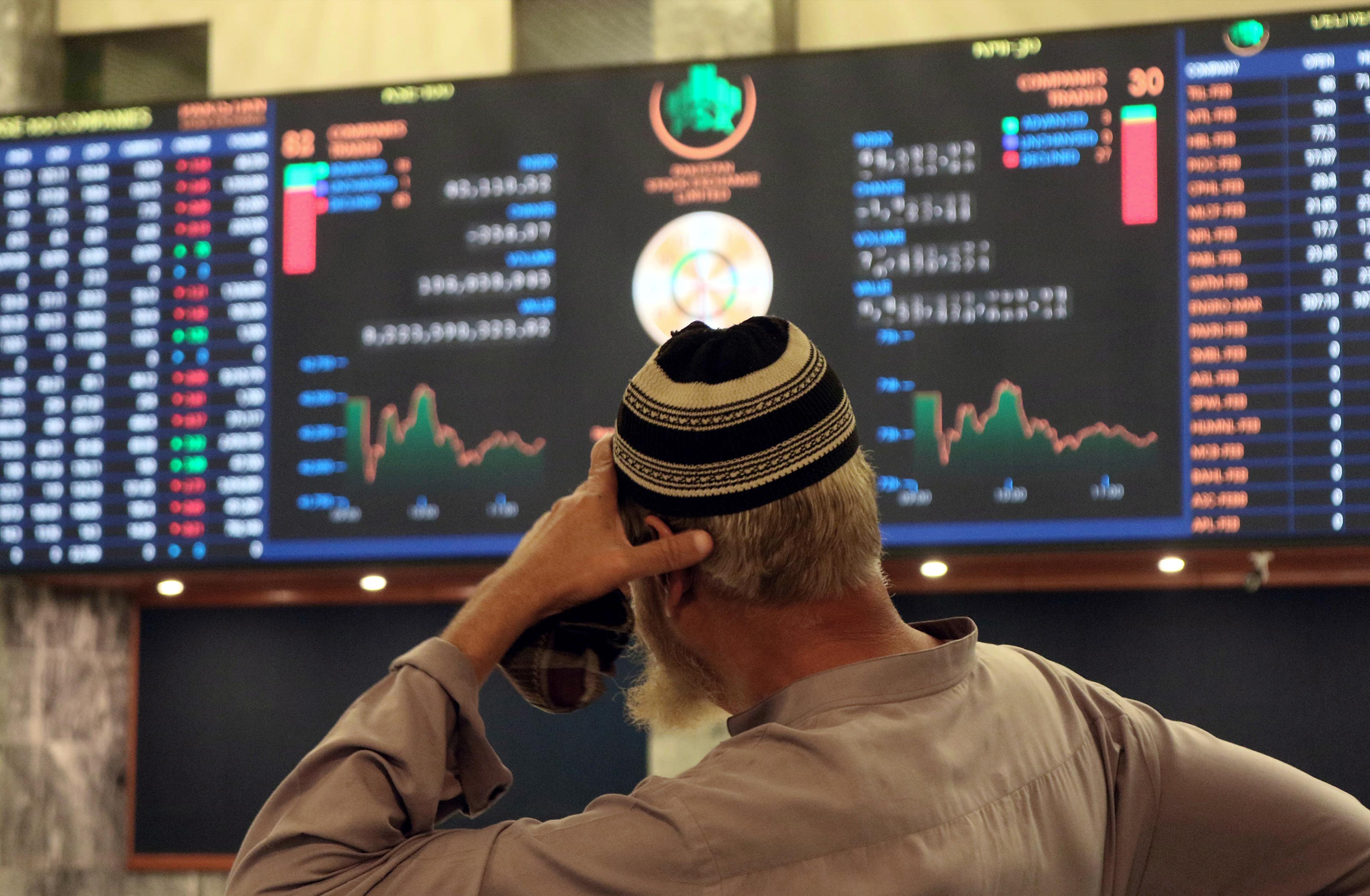 A Pakistani stockbroker monitors the latest share prices during a trading session at the Pakistan Stock Exchange in Karachi, Pakistan, on Feb. 10. The sluggish performance of the market was attributed to the delay in concluding the ninth review of a seve