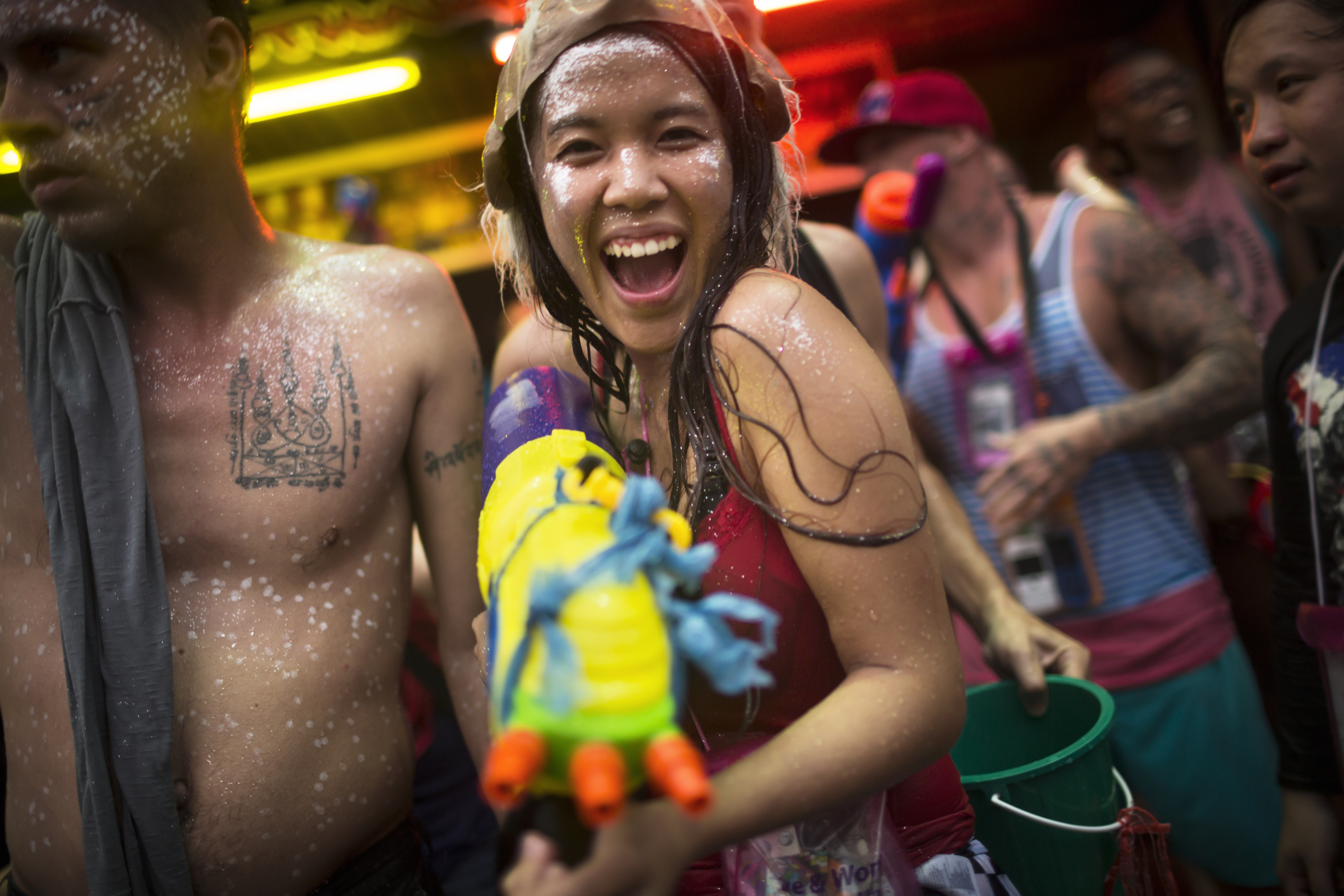 Tourist with water gun celebrates during Songkran
