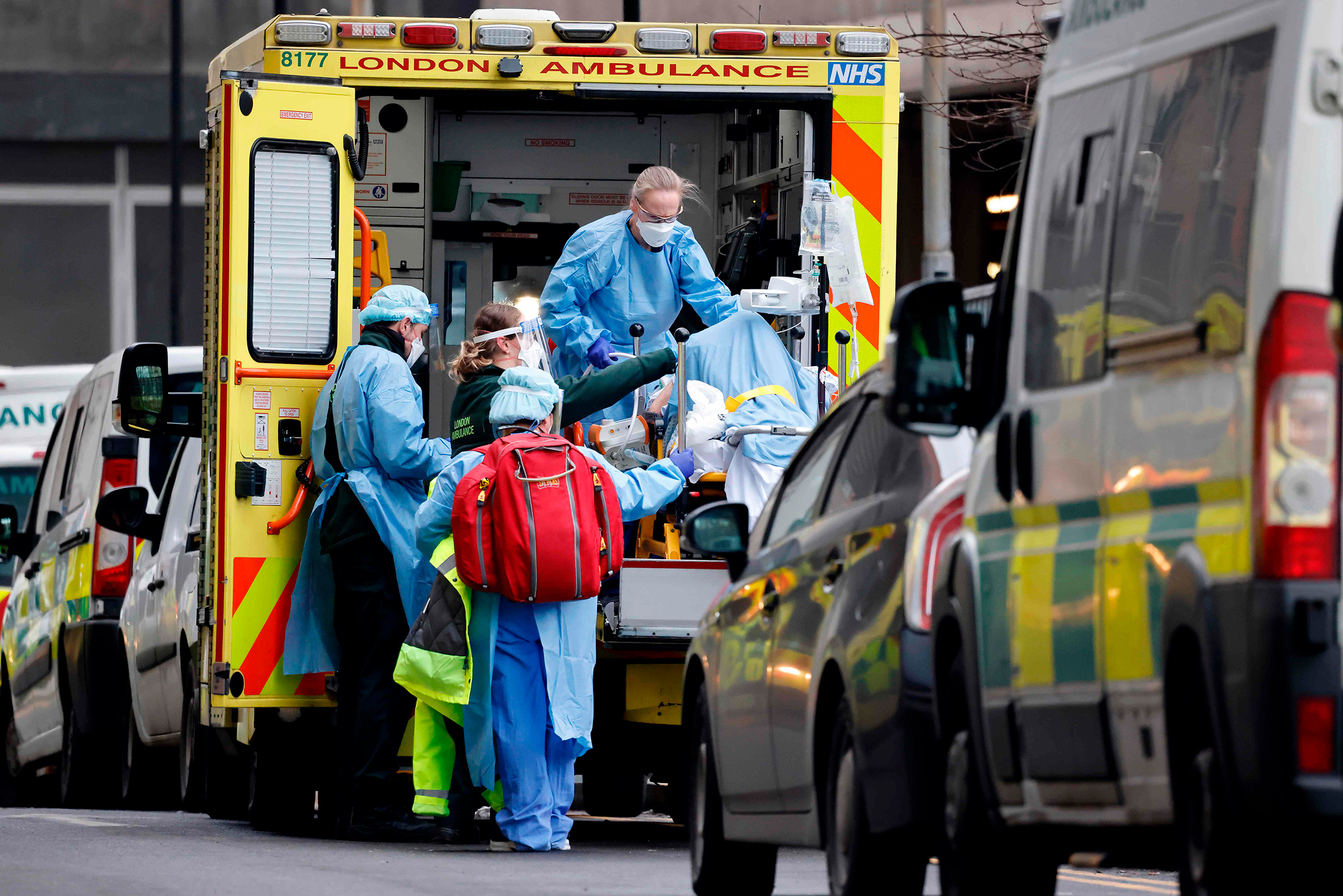 A patient is taken from an ambulance by staff wearing PPE equipment at the Royal Free Hospital, London, on Jan. 11 as surging cases of Covid-19 are placing health services under increasing pressure