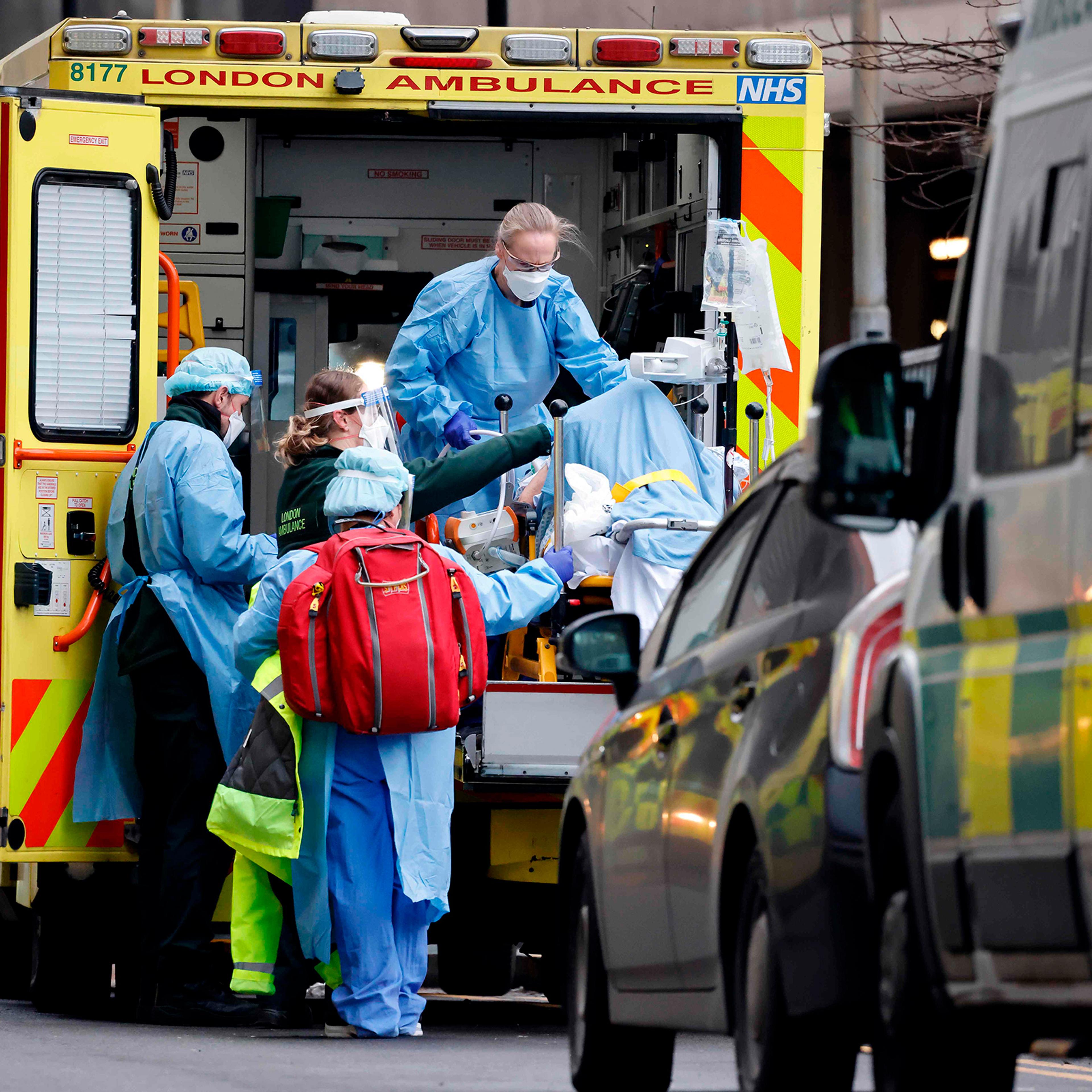 A patient is taken from an ambulance by staff wearing PPE equipment at the Royal Free Hospital, London, on Jan. 11 as surging cases of Covid-19 are placing health services under increasing pressure