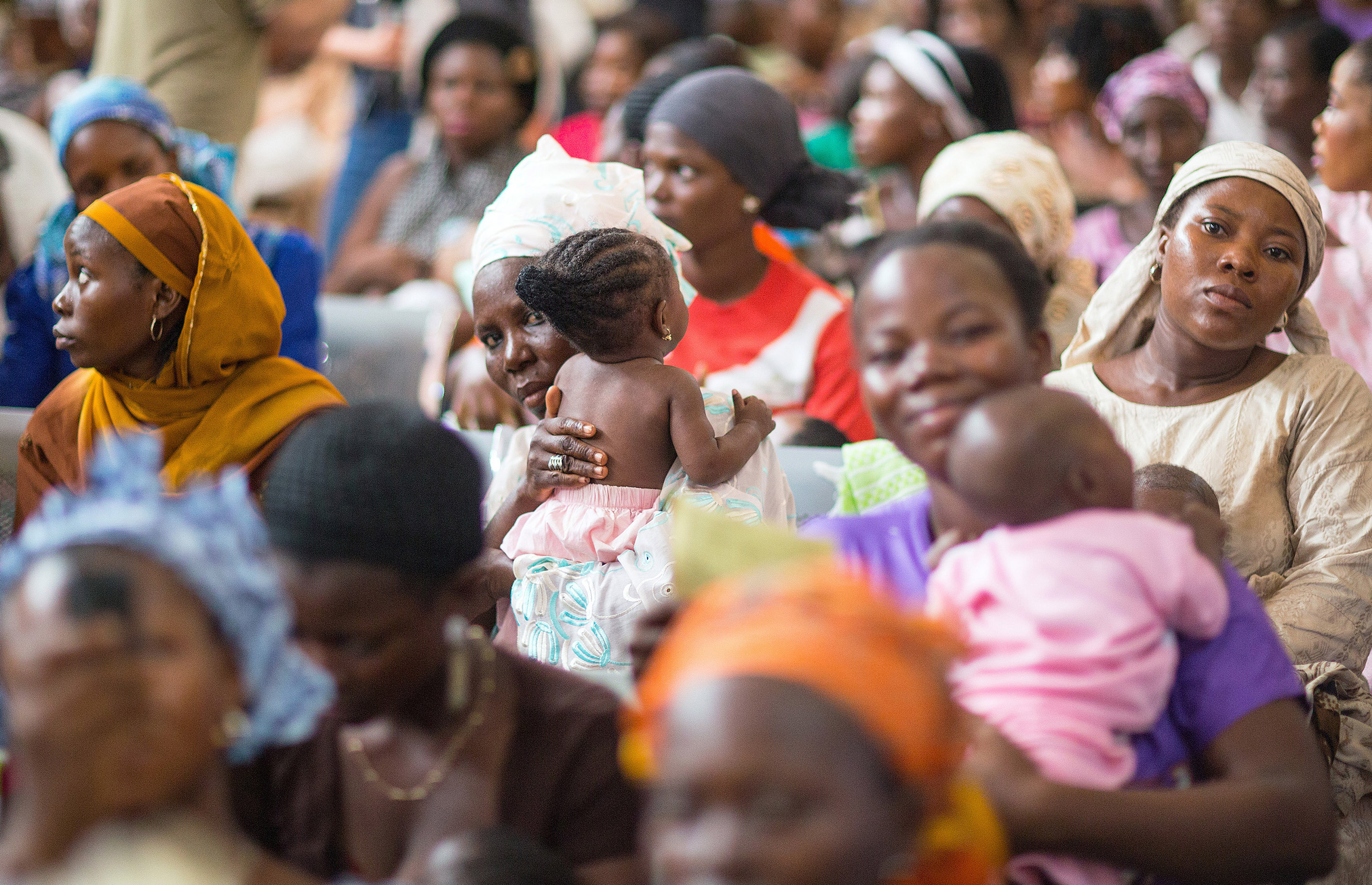 Mothers and their babies wait at a health center which provides vaccinations against polio in Abeokuta, Nigeria, 11 June 2014. German Minister of Economic Cooperation and Development, Gerd Mueller (CSU) traveled to the Nigeria for a three day visit. Phot