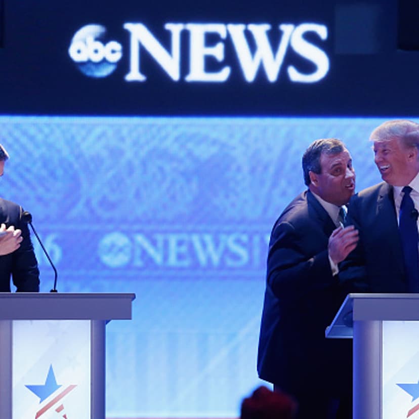 Republican presidential candidates New Jersey Governor Chris Christie (2nd R) and Donald Trump visit as Sen. Marco Rubio (R-FL) (L) stands close by during a commercial break in the Republican presidential debate at St. Anselm College February 6, 2016 in
