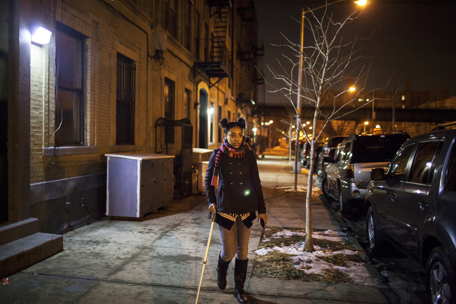 February 1, 2014. Sarah walks out of a Zero Nation meeting at Syrin's house in East New York. She's still using her cane but improving quickly, and even starting to dance again.