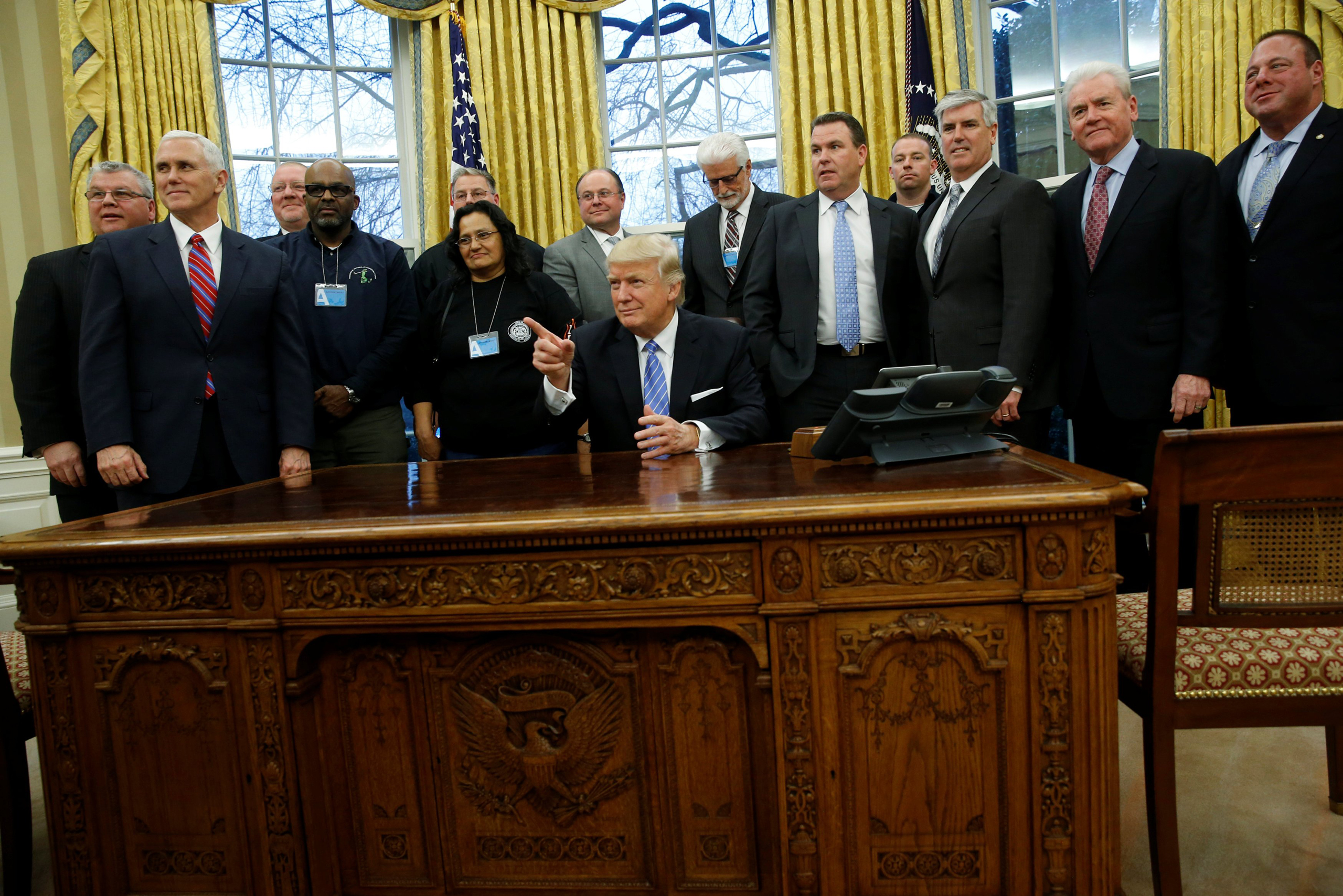 U.S. President Donald Trump gathers labor leaders in the Oval Office after their meeting at the White House in Washington, U.S. January 23, 2017. REUTERS/Jonathan Ernst