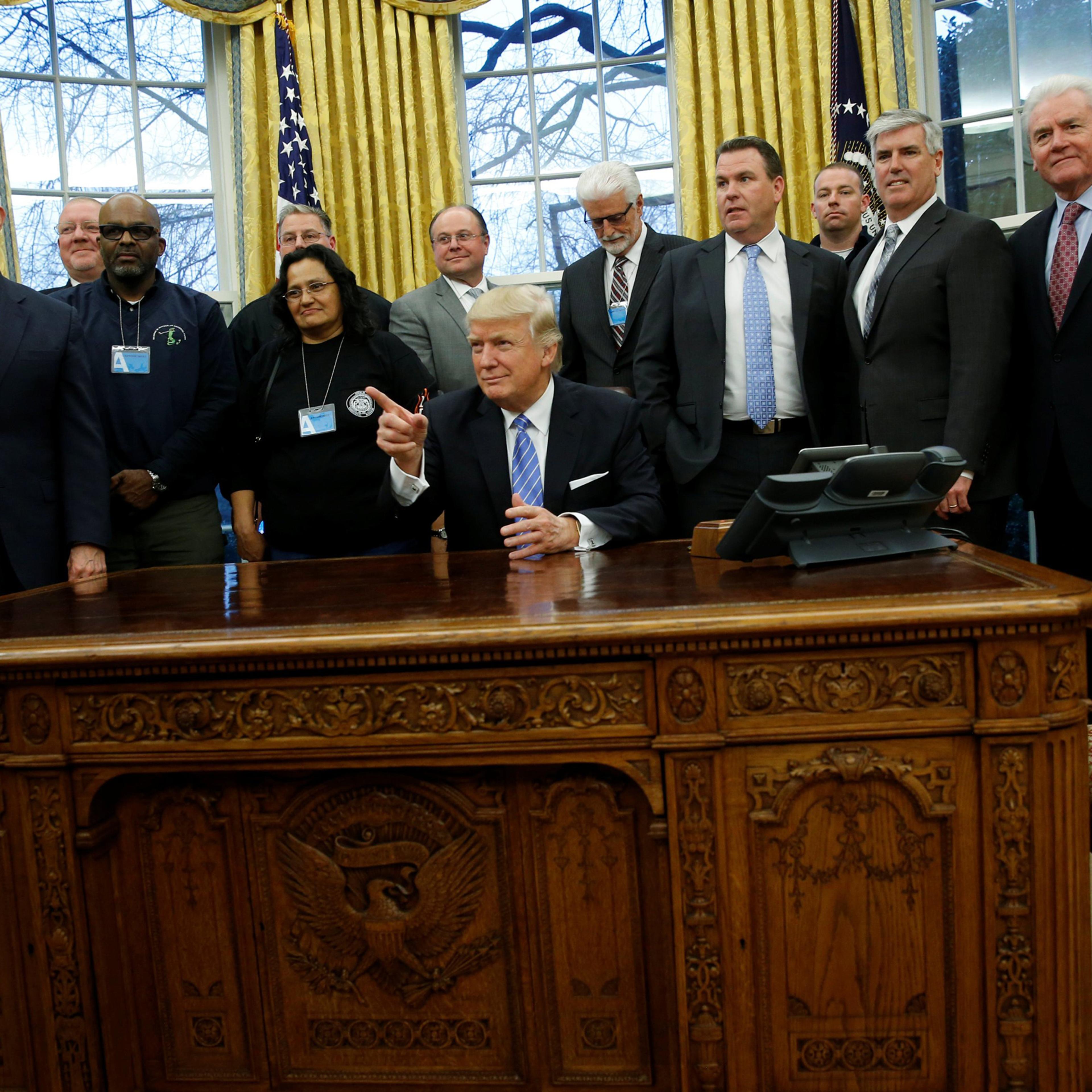 U.S. President Donald Trump gathers labor leaders in the Oval Office after their meeting at the White House in Washington, U.S. January 23, 2017. REUTERS/Jonathan Ernst