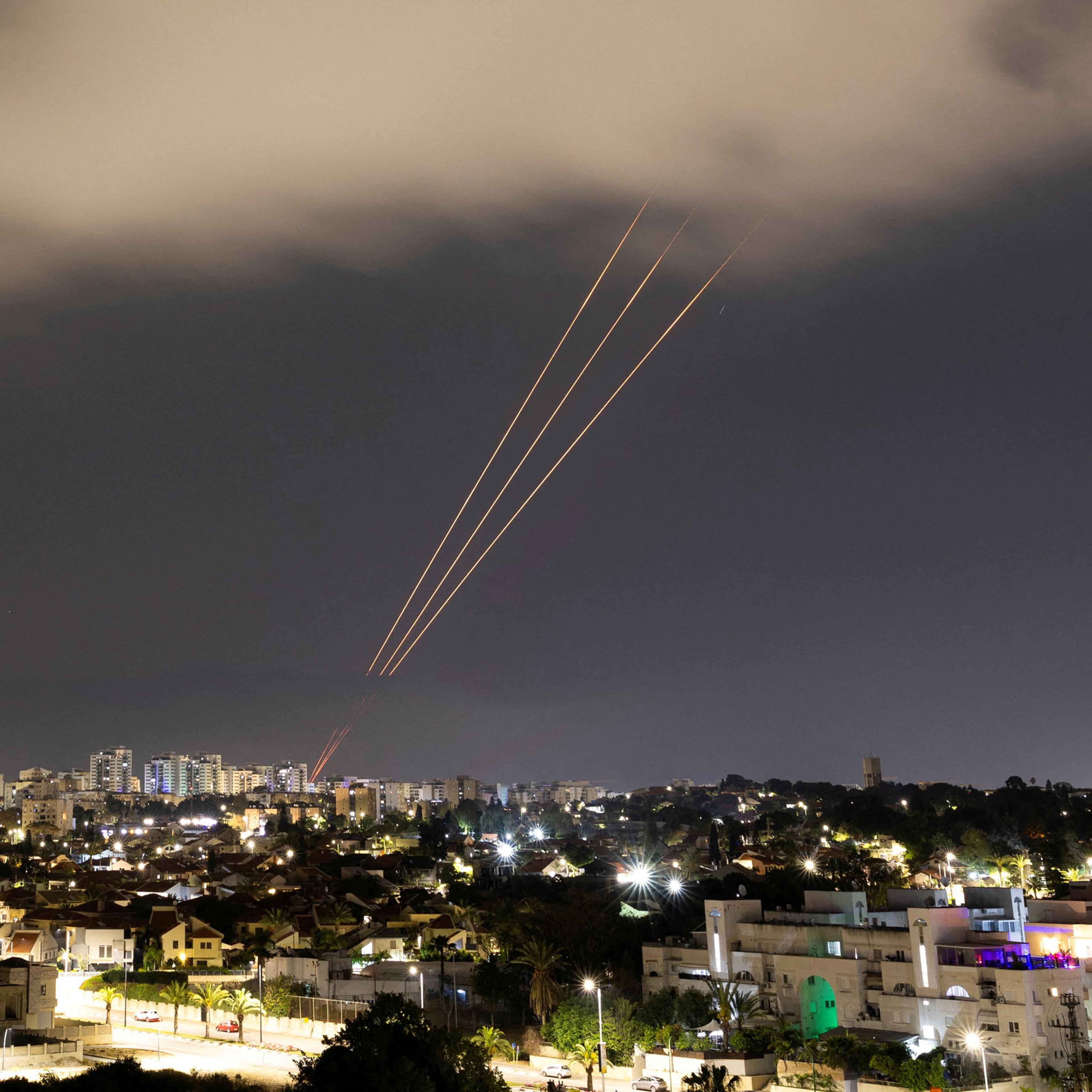 An anti-missile system operates after Iran launched drones and missiles towards Israel