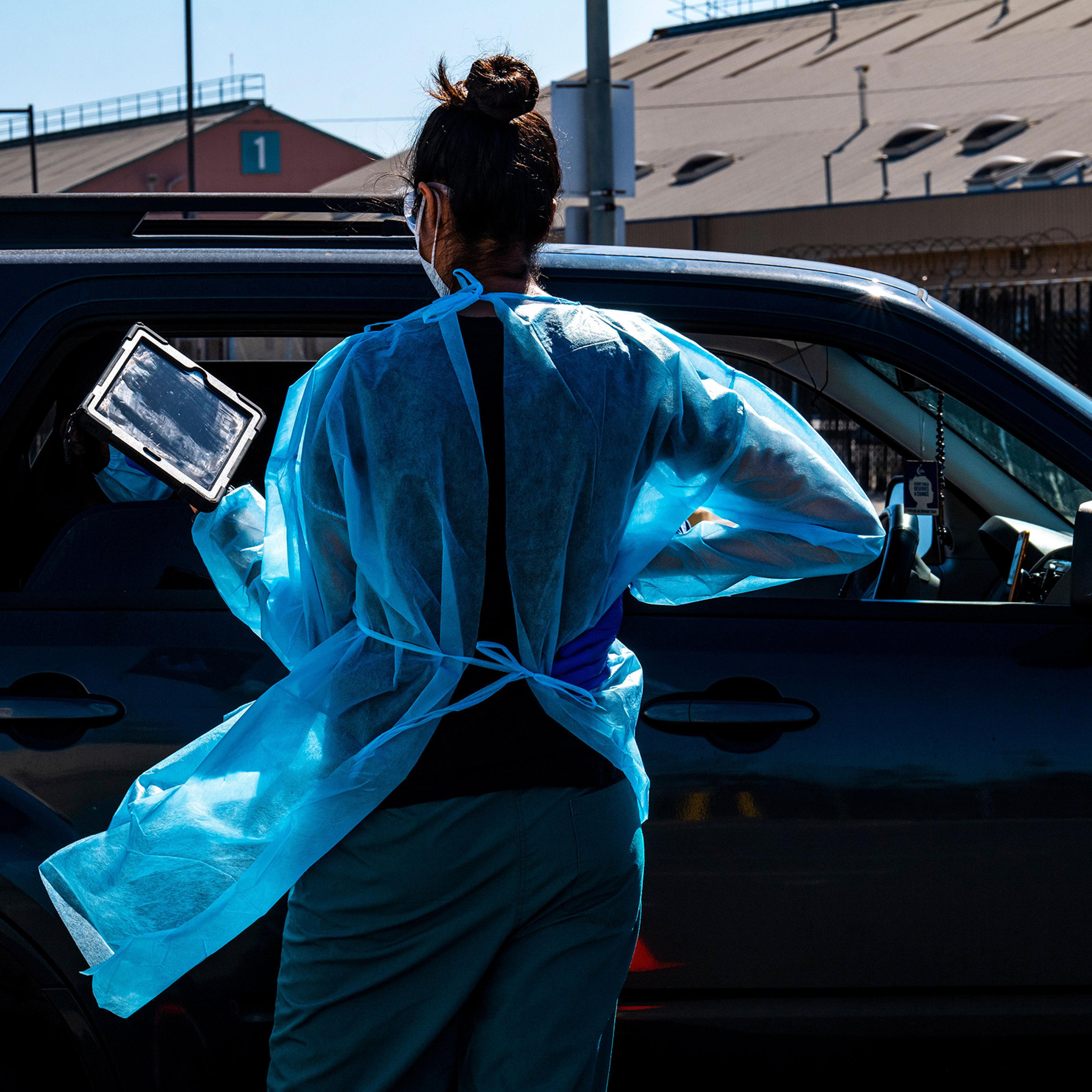 A medical worker interviews a person before administering a rapid Covid-19 test in Oakland, Calif., on Oct. 12.