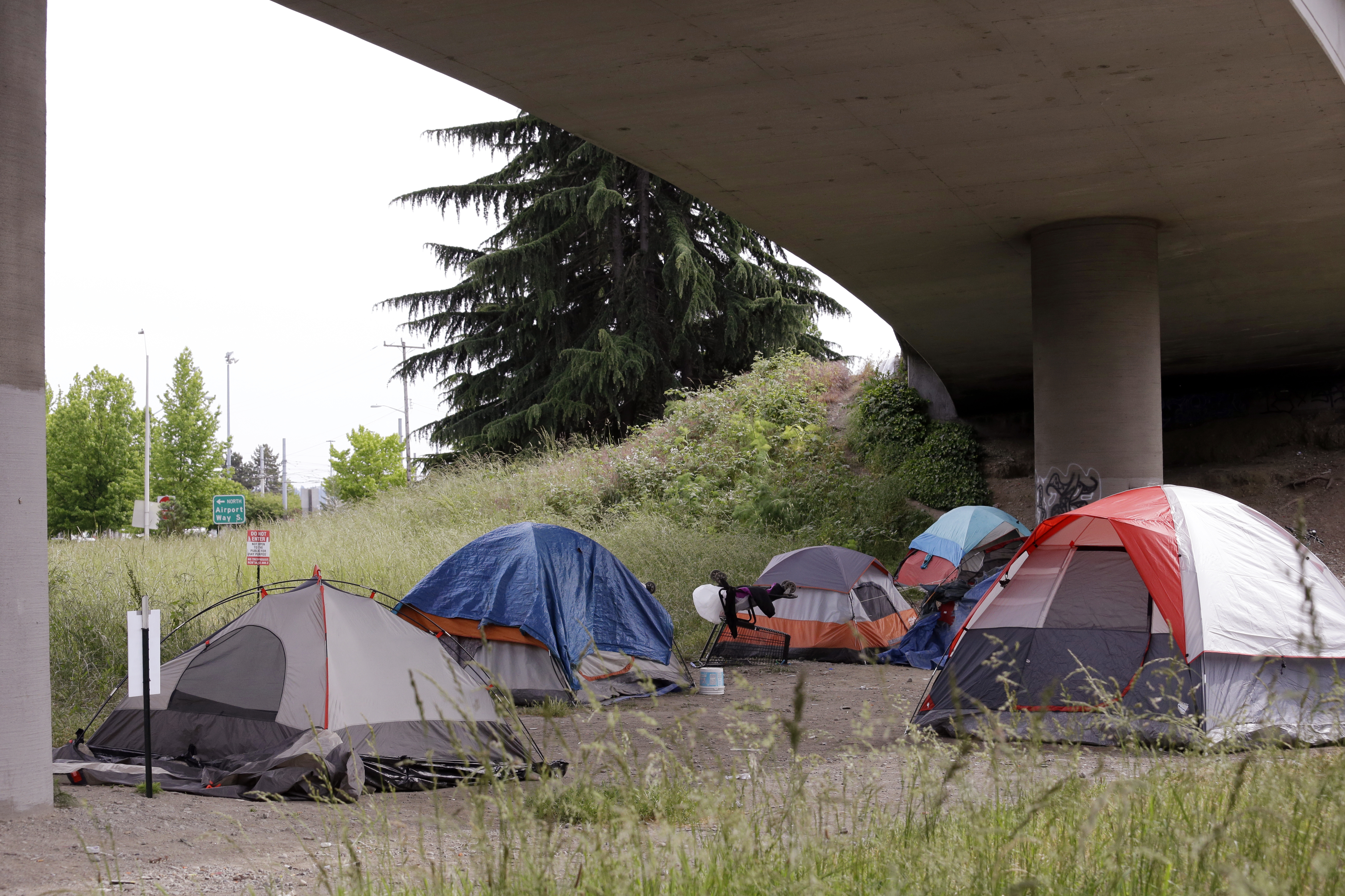 Tents line a small green space below Interstate 90 and a short walk to a homeless area known as the Jungle, May 17, 2016, in Seattle.