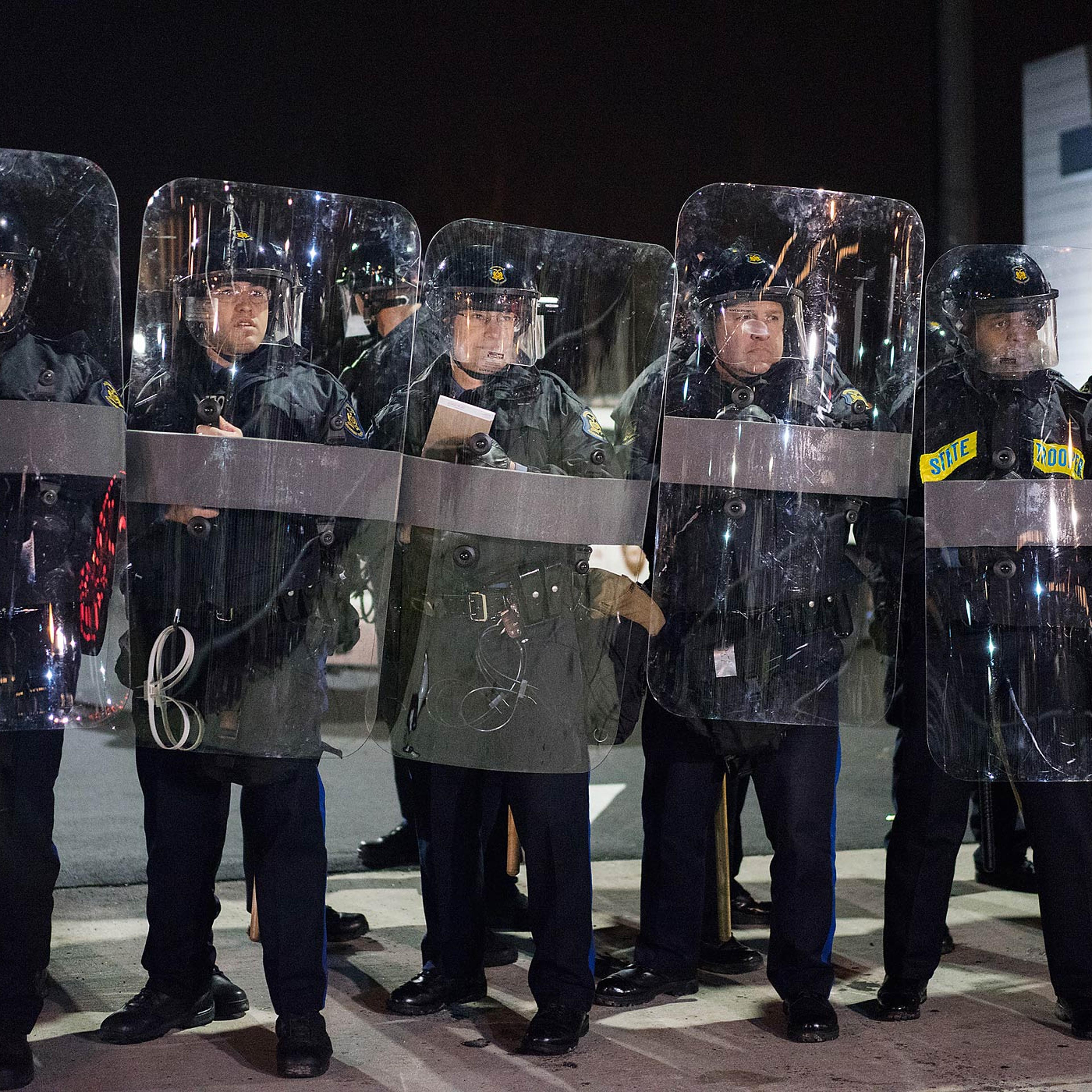 Police officers in riot gear stand guard in Ferguson, Mo. on Nov. 24, 2014