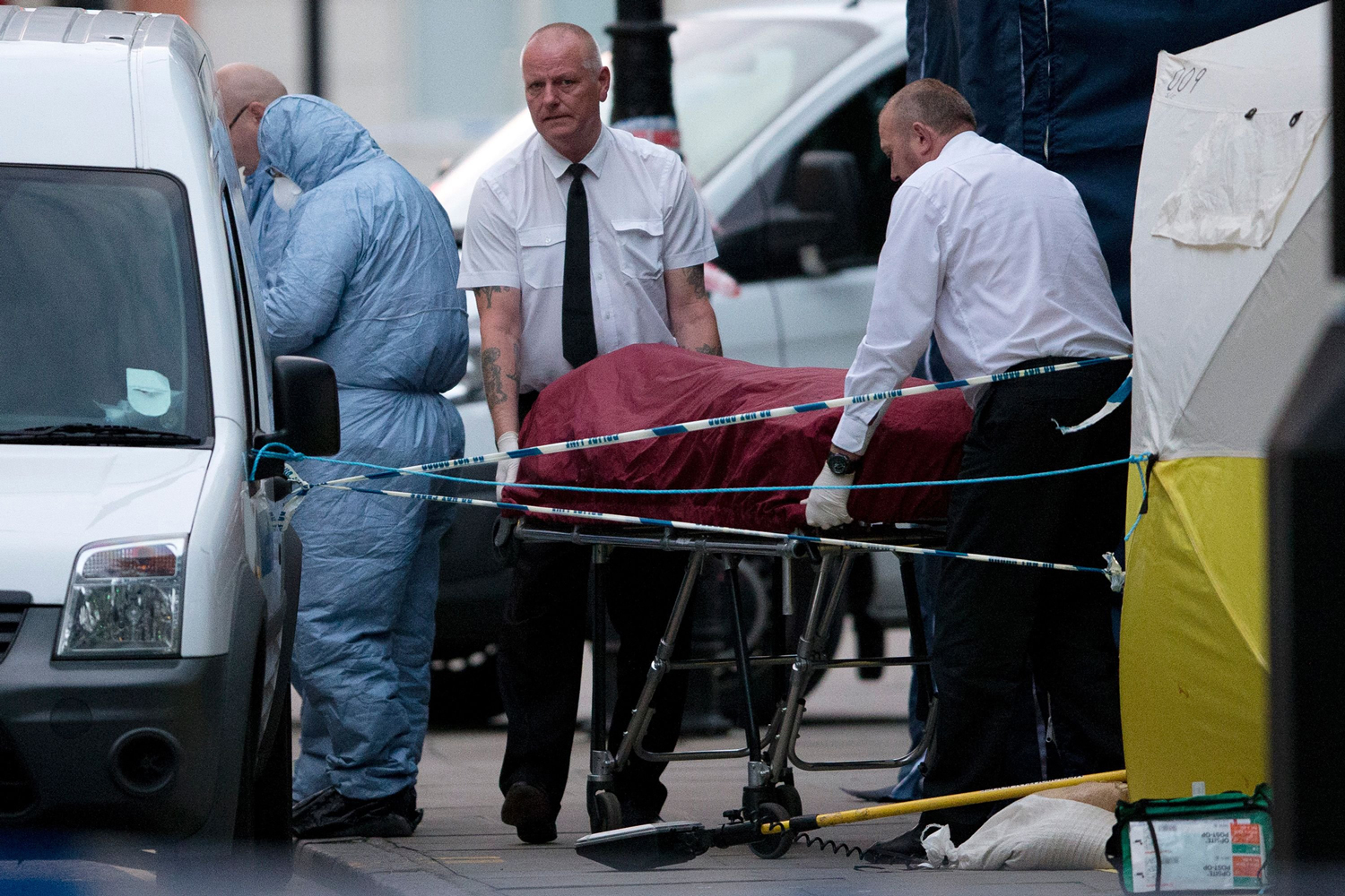 A private ambulance crew removes a body from Russell Square in London, after a woman in her 60s was killed, on Aug. 4, 2016. Five more were injured in the attack late on Aug. 3.
