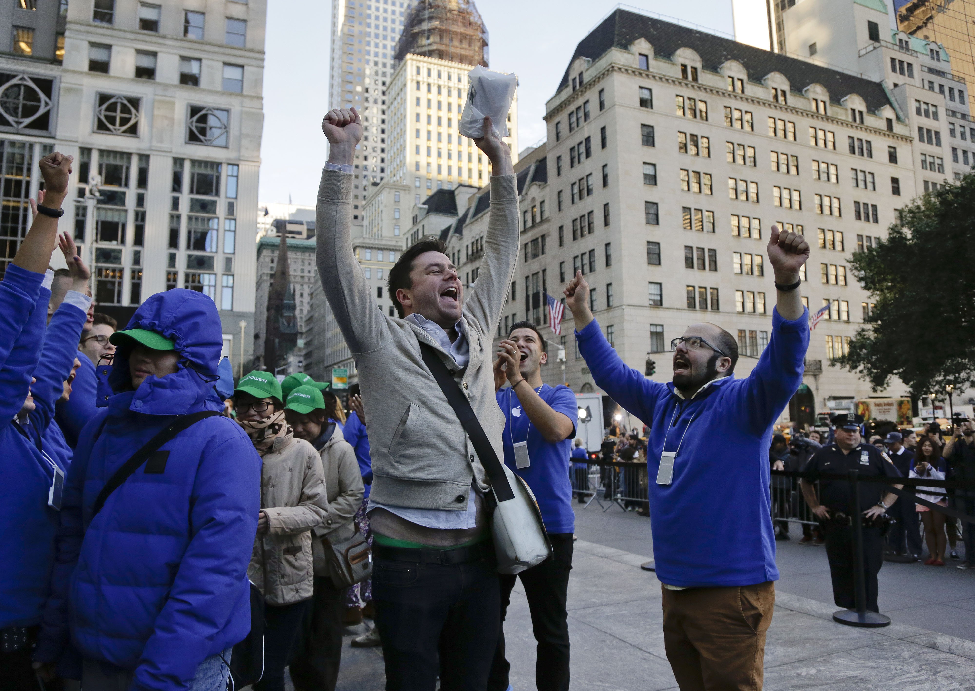 Andreas Gibson celebrates as he exits the Apple store after being the first to purchase an iPhone 6 Plus on Sept. 19, 2014 in New York.