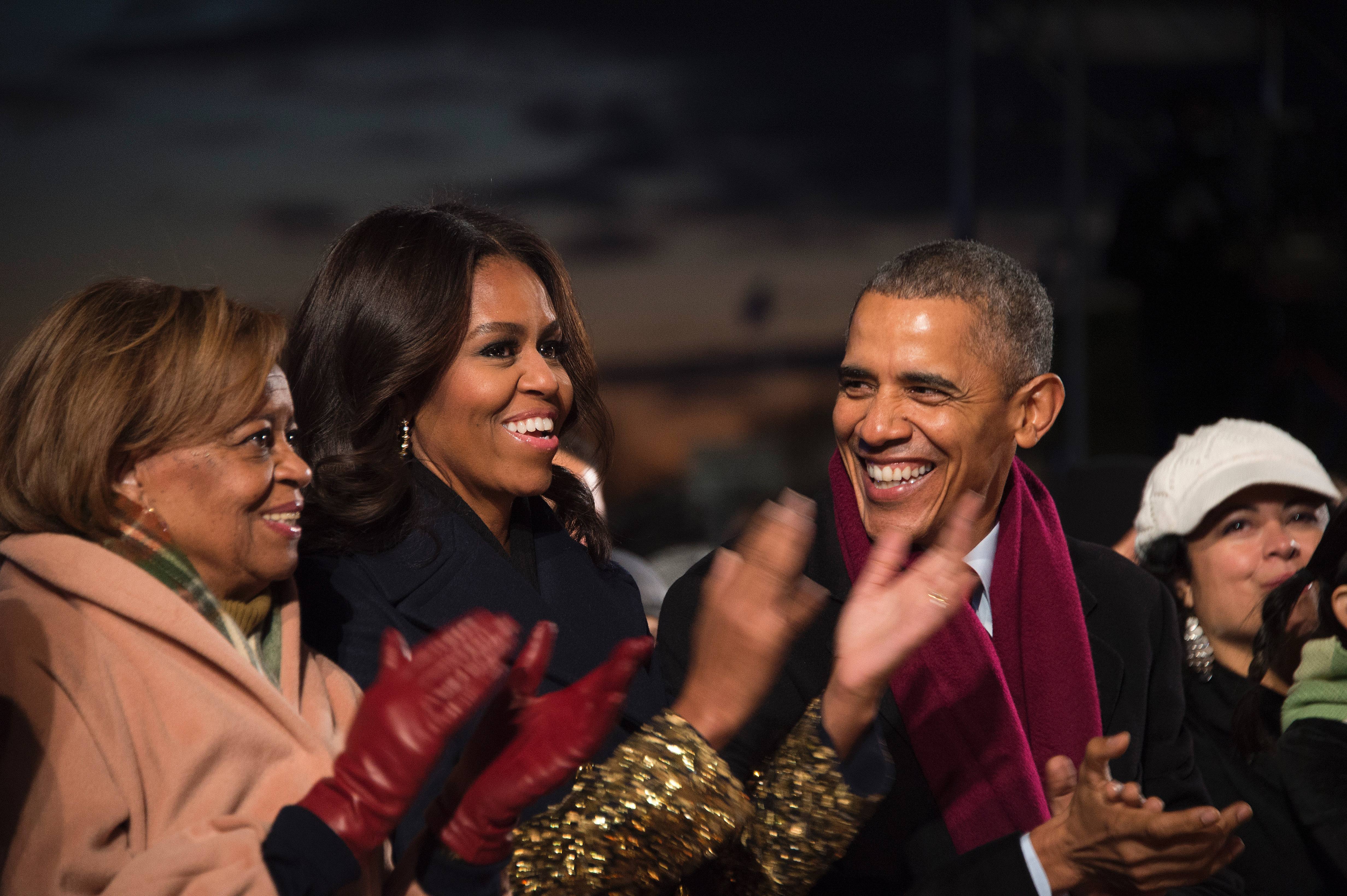 President Barack Obama shares a laugh with First Lady Michelle Obama and his mother-in-law Marion Robinson