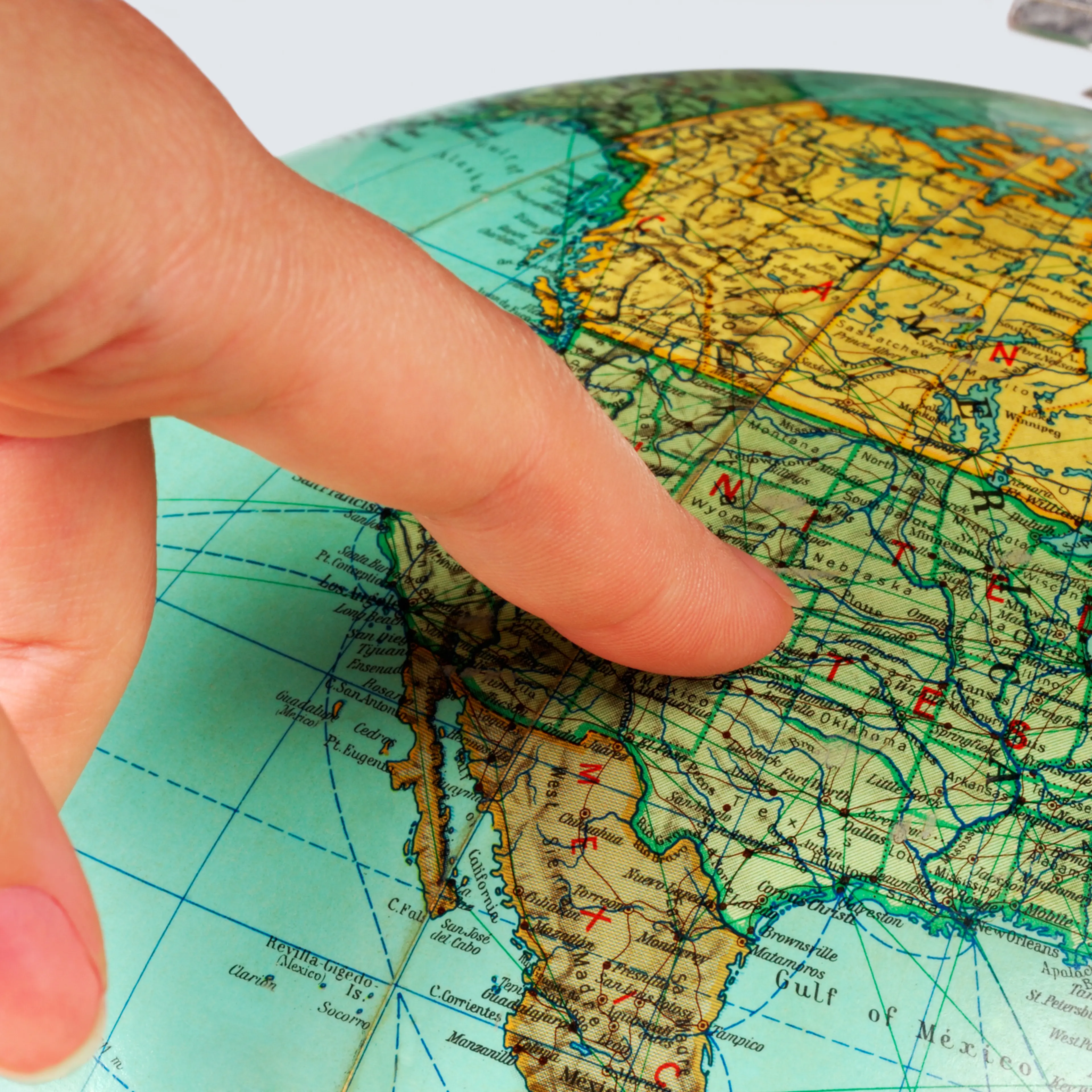 globe with a finger pointing at the United States