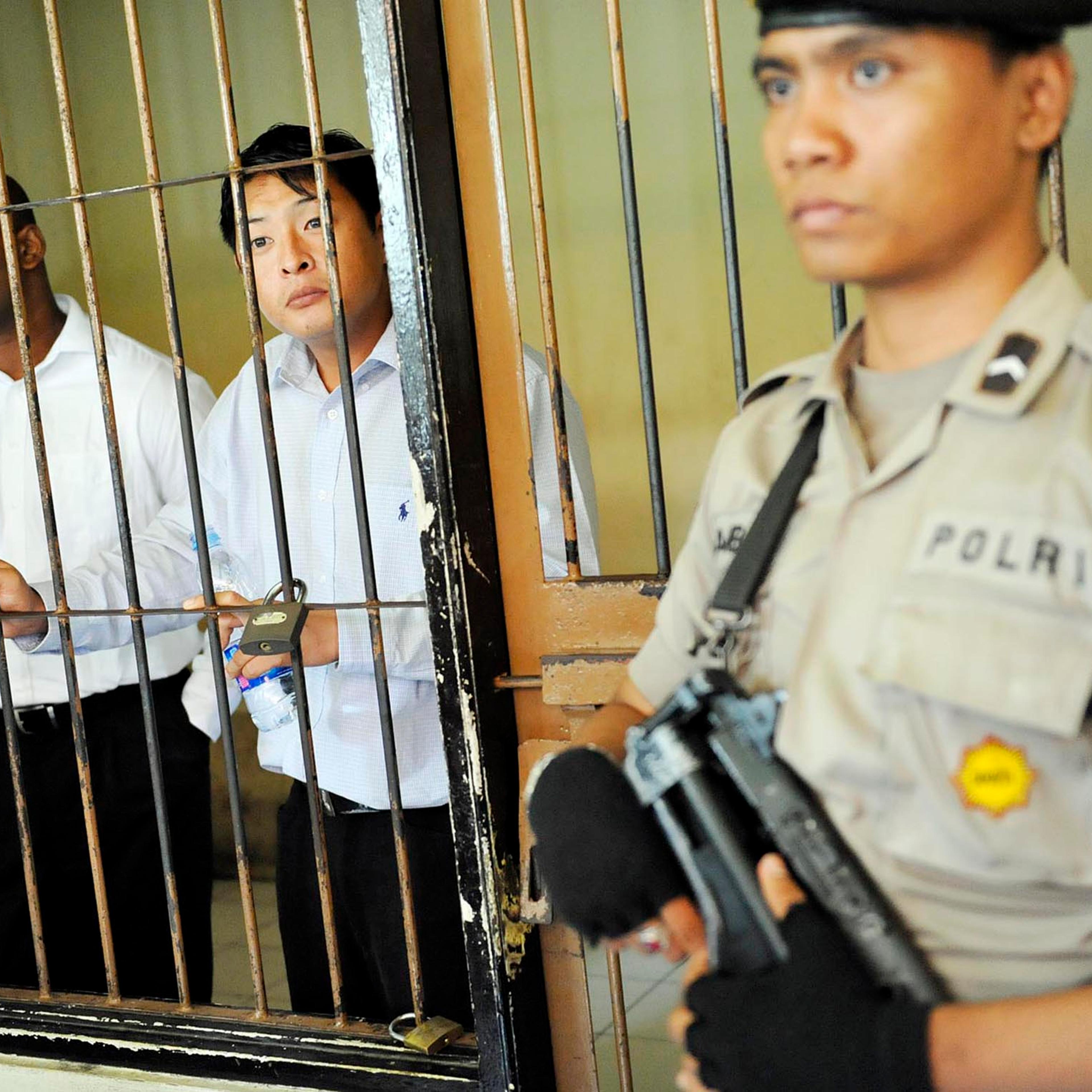 Australian death row prisoners Andrew Chan and Myuran Sukumaran are seen in a holding cell waiting to attend a review hearing in the District Court of Denpasar in Bali