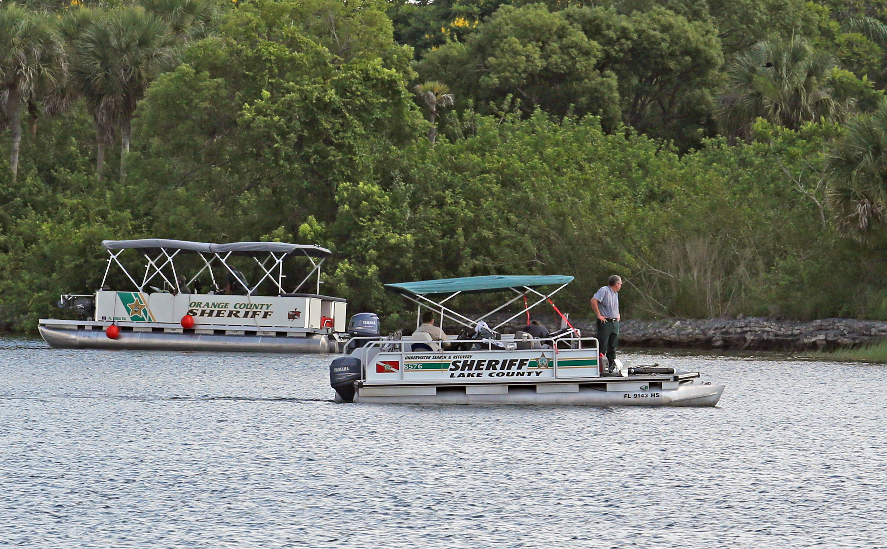 Orange County Sheriff's Marine Unit search for a young boy Wednesday, June 15, 2016 after the boy was grabbed Tuesday night by an alligator at Grand Floridian Resort at Disney World near Lake Buena Vista, Fla.