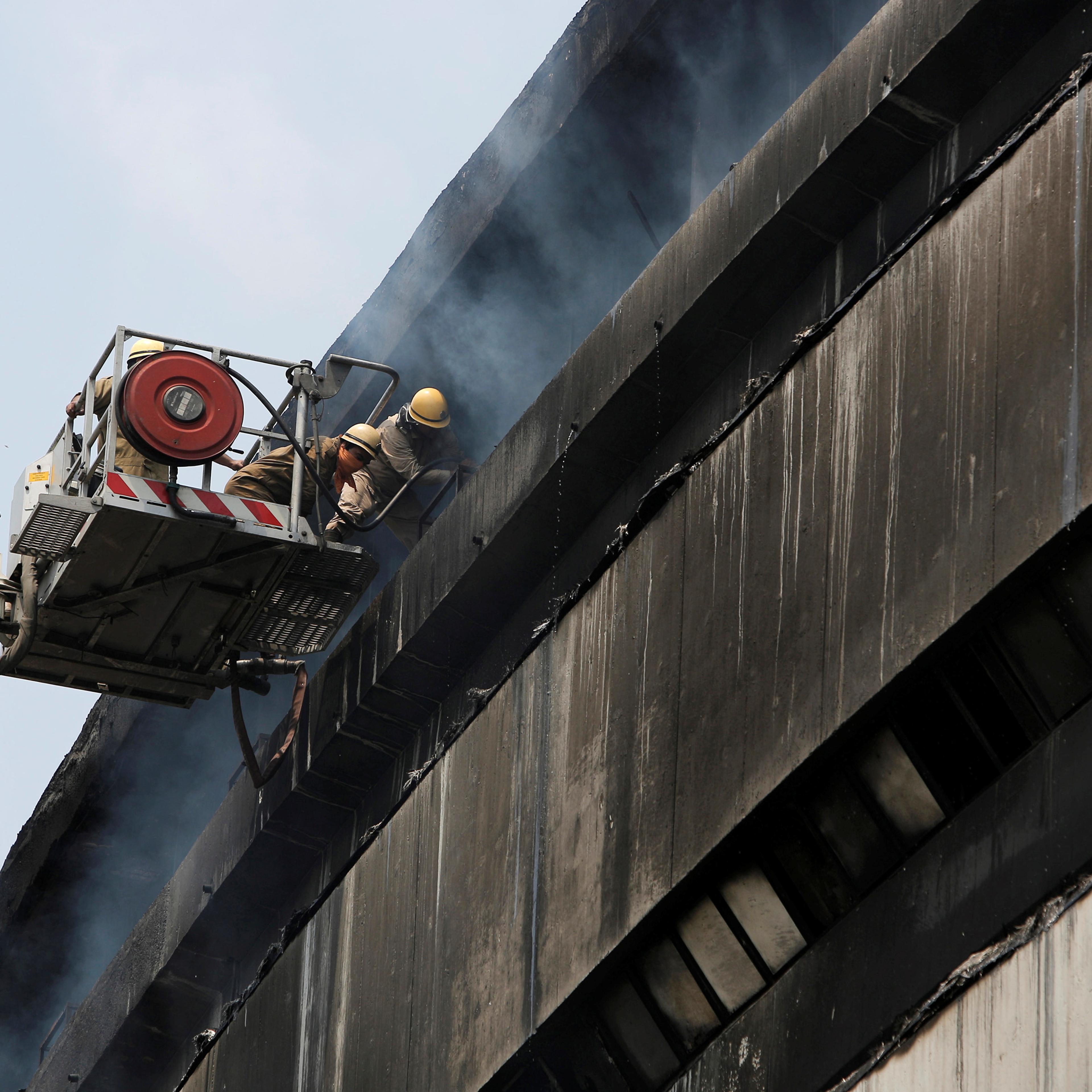 Firefighters work to extinguish fire in the building of India's National Museum of Natural History in New Delhi