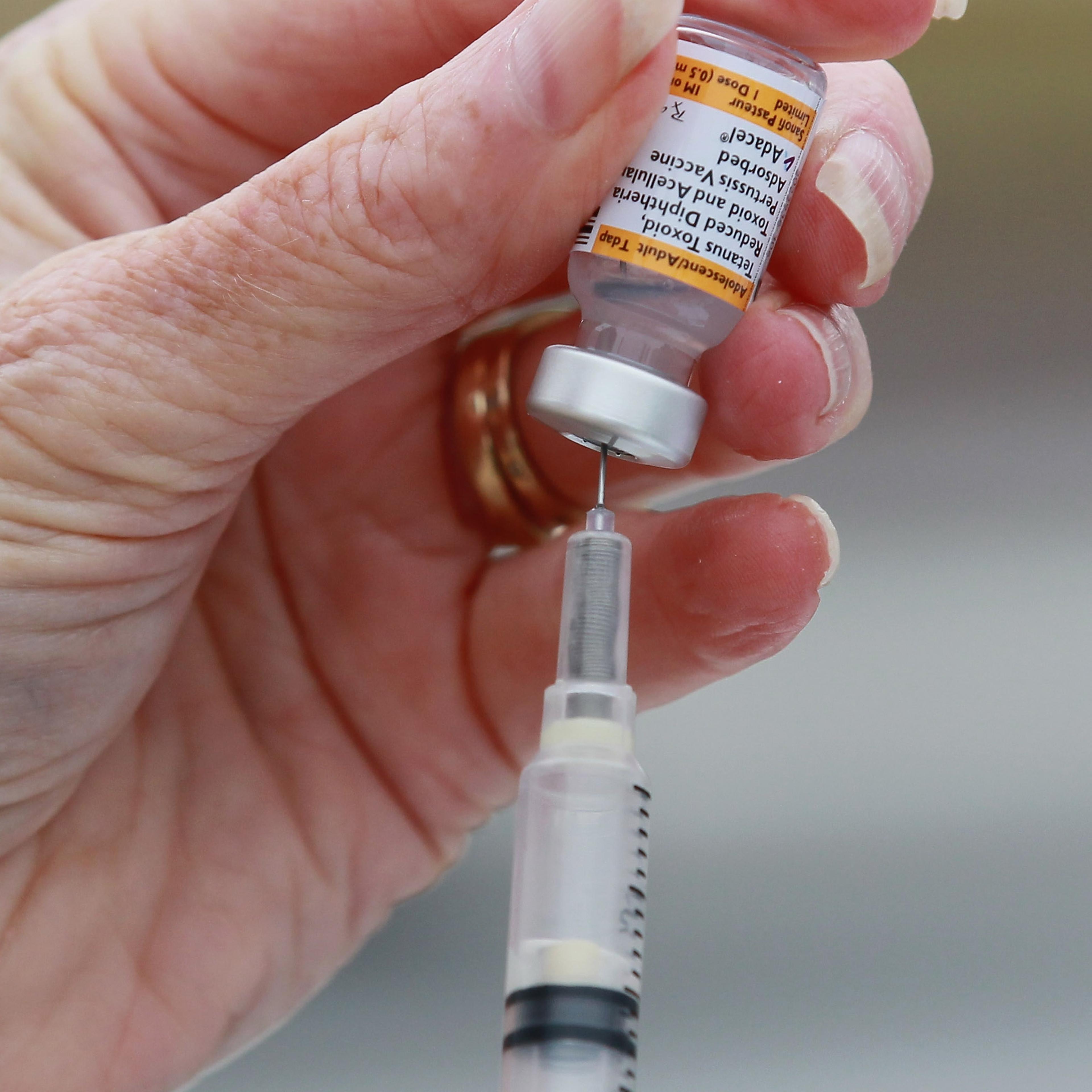 A nurse prepares a Tdap vaccination during the Solano County health fair August 11, 2010 in Vallejo, Calif. According to authorities, an infant died of Whooping Cough in San Diego.