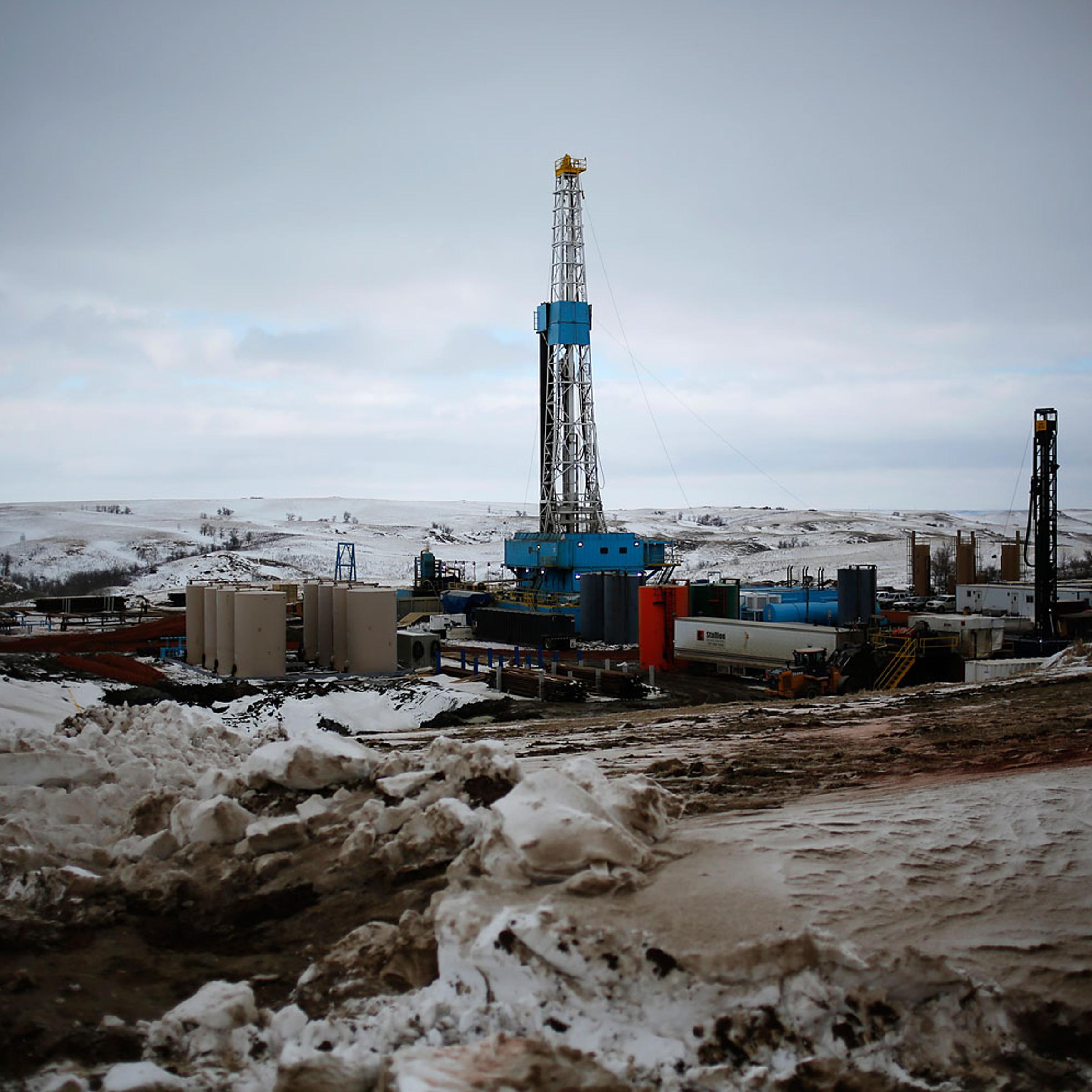 An oil derrick is seen at a fracking site for extracting oil outside of Williston