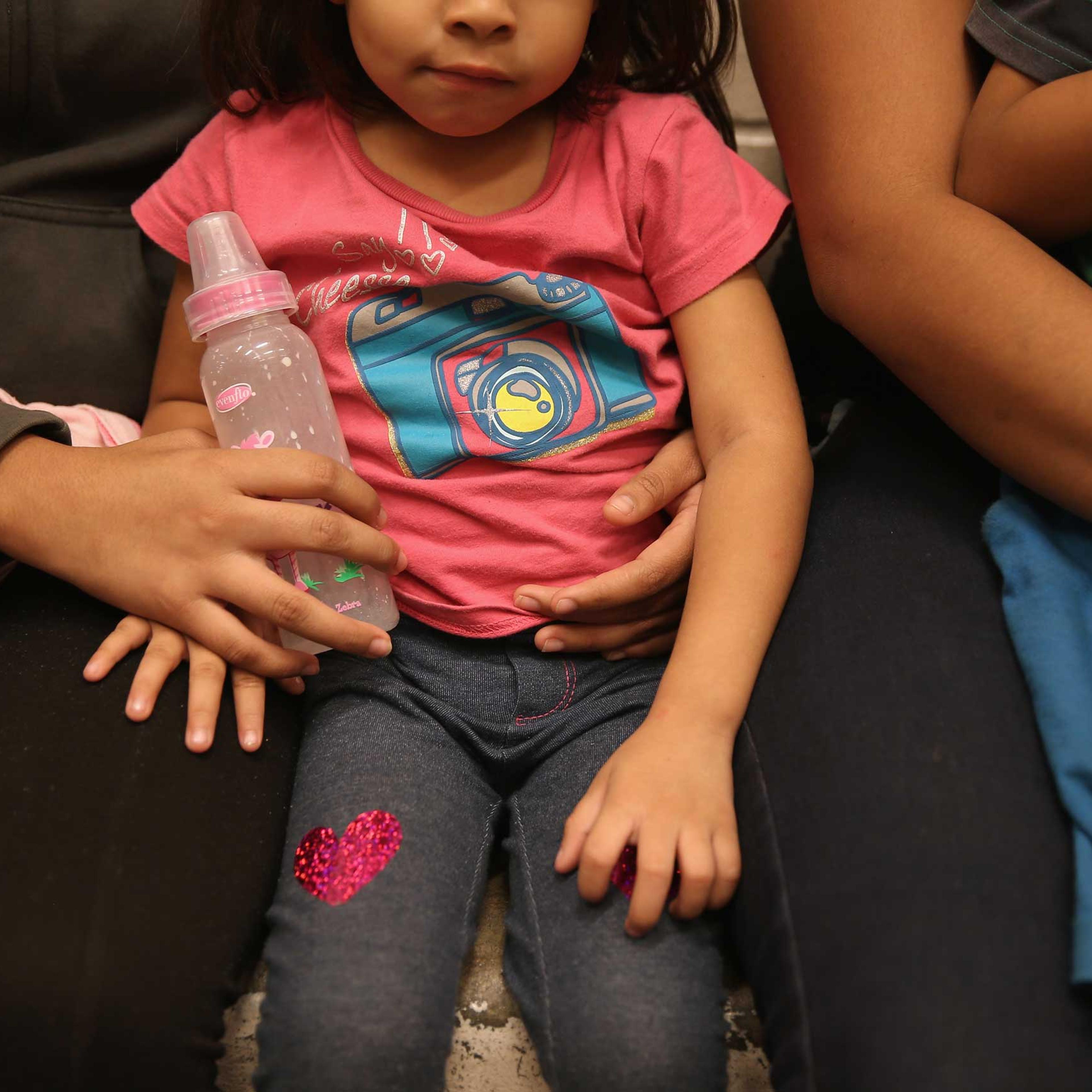 Women and children sit in a holding cell at a U.S. Border Patrol processing center after being detained by agents near the U.S.-Mexico border on Sept. 8, 2014 near McAllen, Texas.