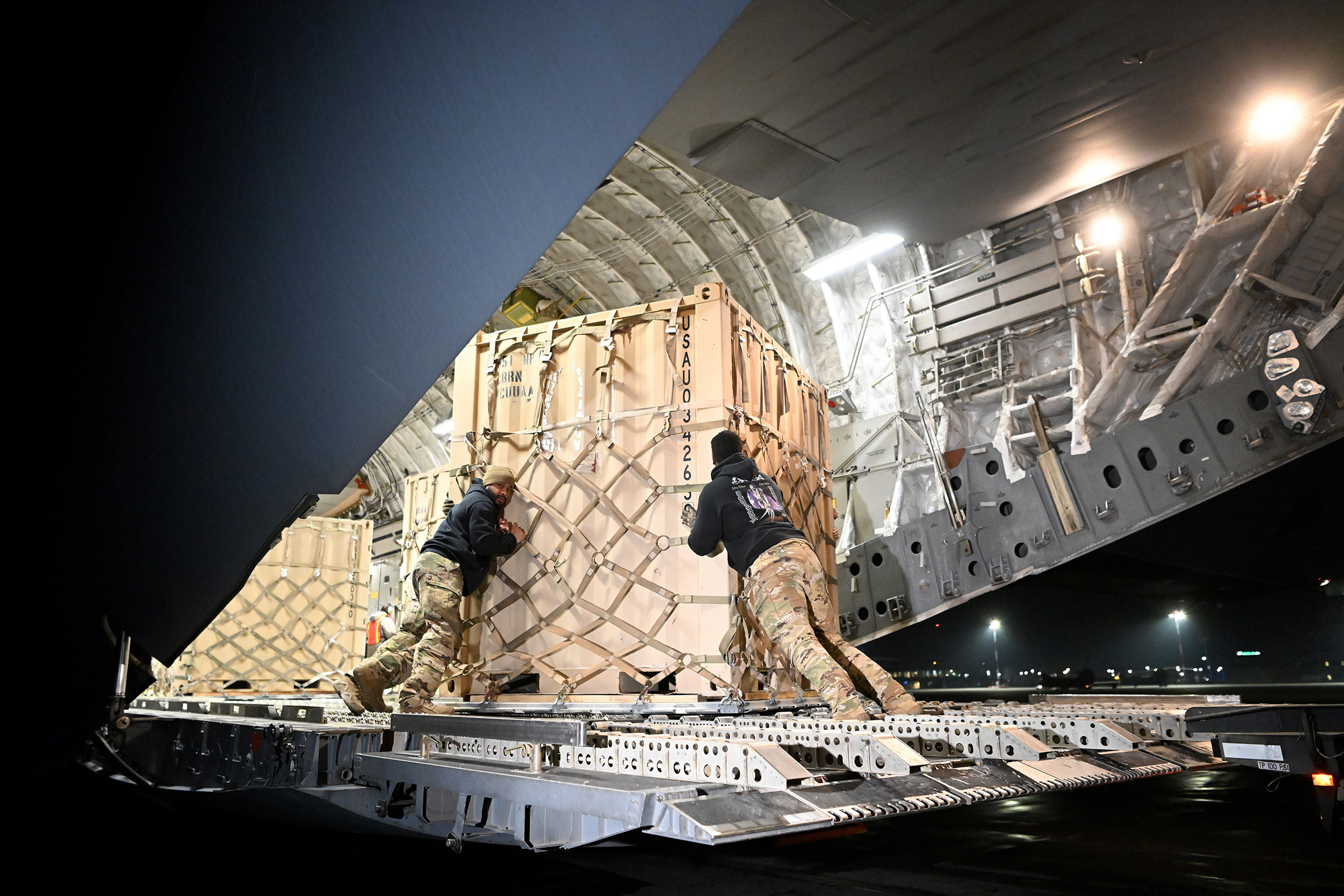 A U.S. military cargo plane transporting supplies bound for Ukraine is unloaded in February at an airfield in Rzeszow, Poland