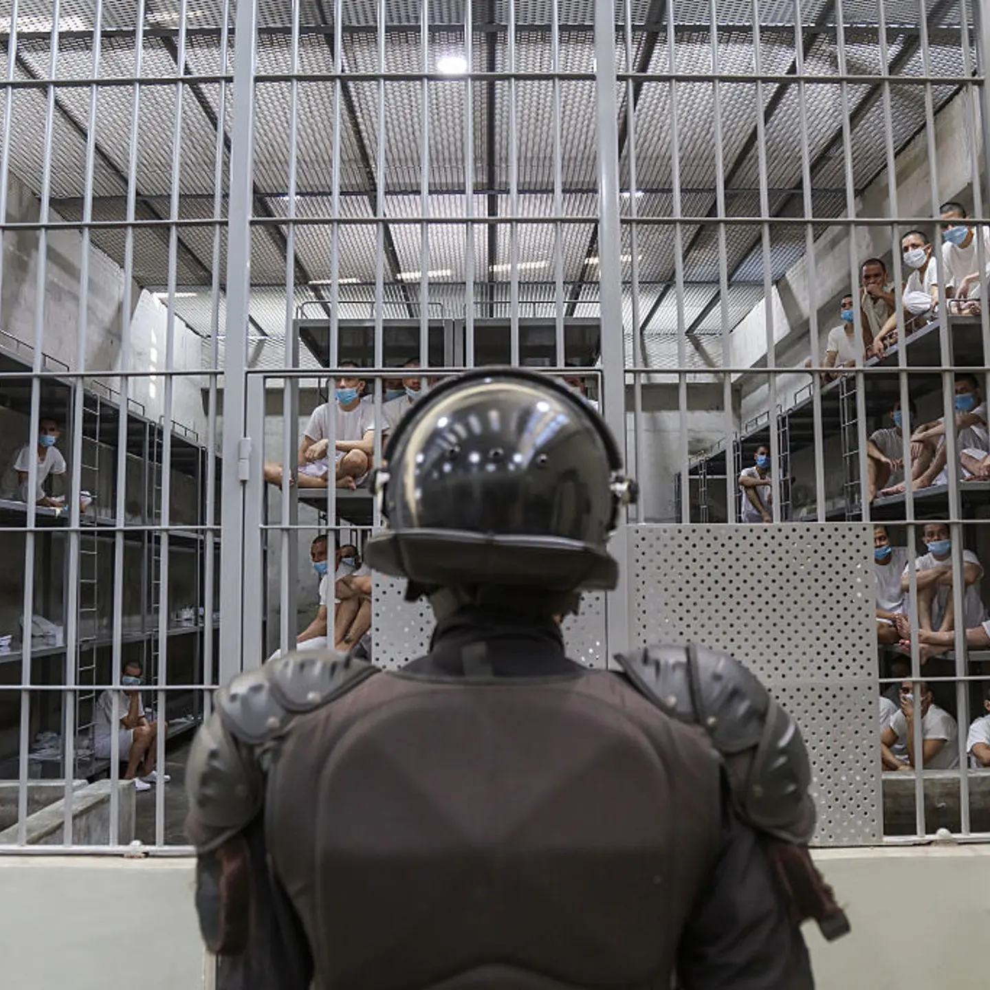 A prison officer guards a cell at maximum security penitentiary CECOT on April 4, 2025 in Tecoluca, San Vicente, El Salvador.