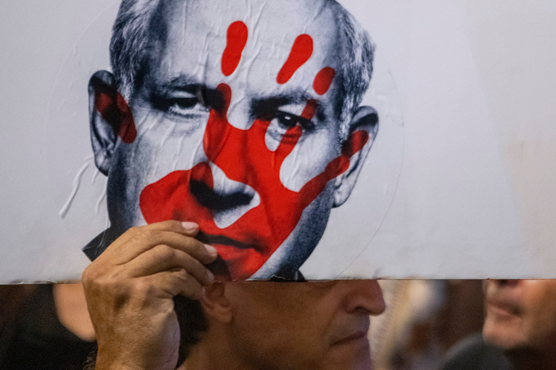 A protestor carries a poster at a mass demonstration condemning Israeli Prime Minister Benjamin Netanyahu and his handling of the hostages being held in Gaza by Hamas, in Tel Aviv on Sept. 1, 2024.