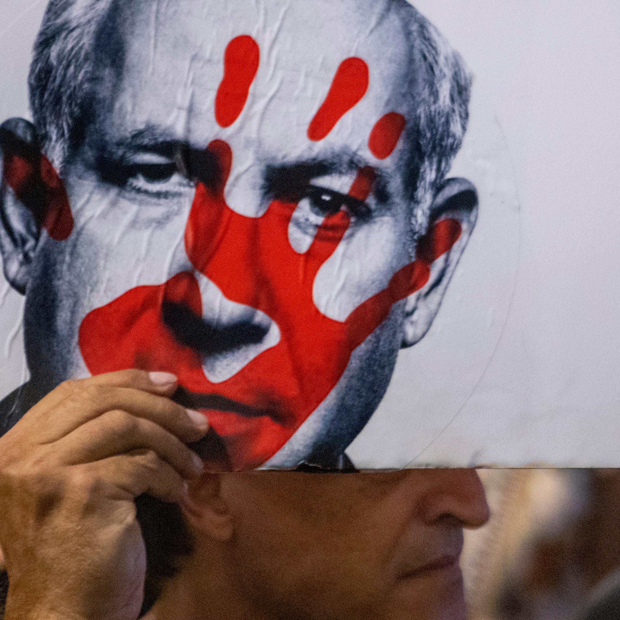 A protestor carries a poster at a mass demonstration condemning Israeli Prime Minister Benjamin Netanyahu and his handling of the hostages being held in Gaza by Hamas, in Tel Aviv on Sept. 1, 2024.