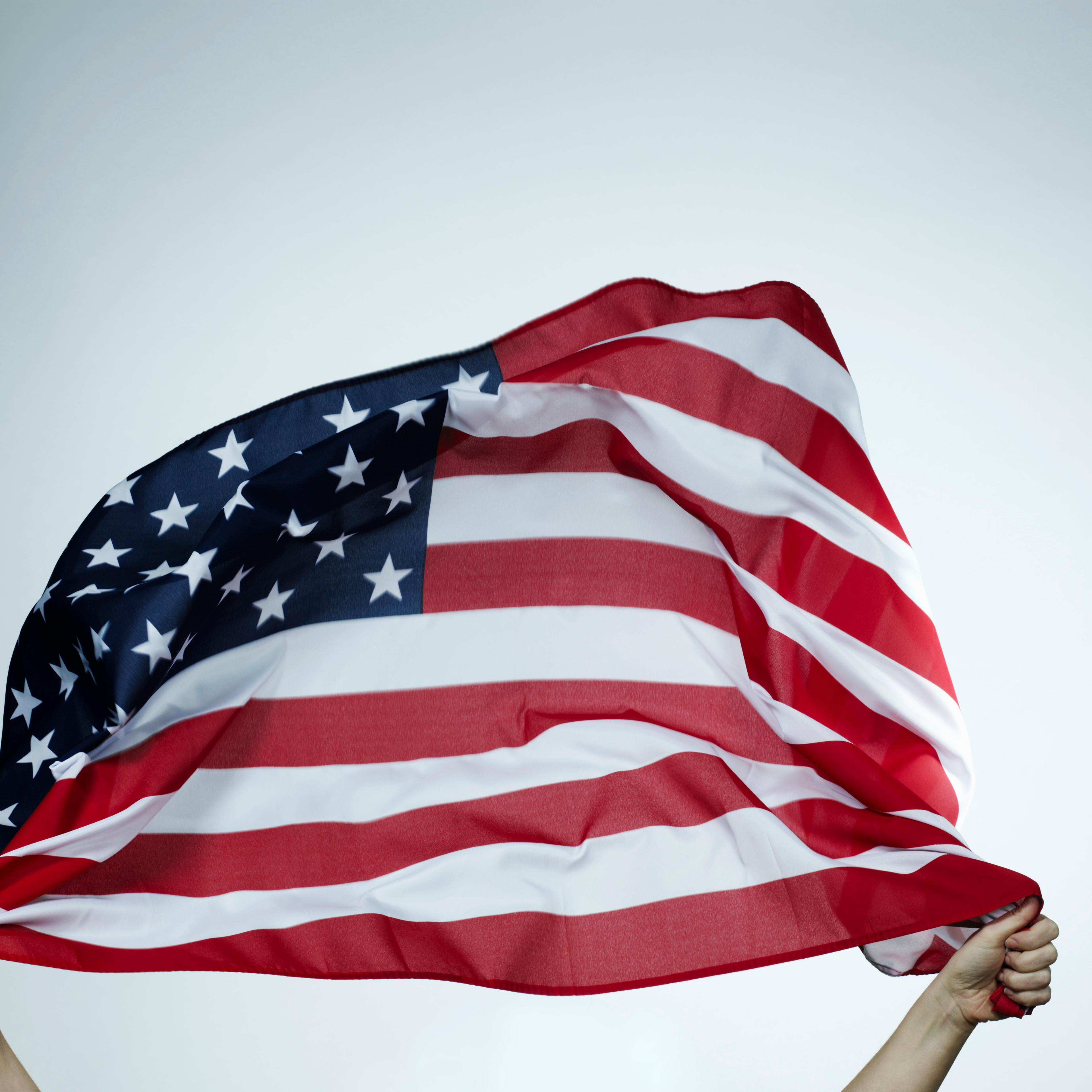 Hands holding American flag