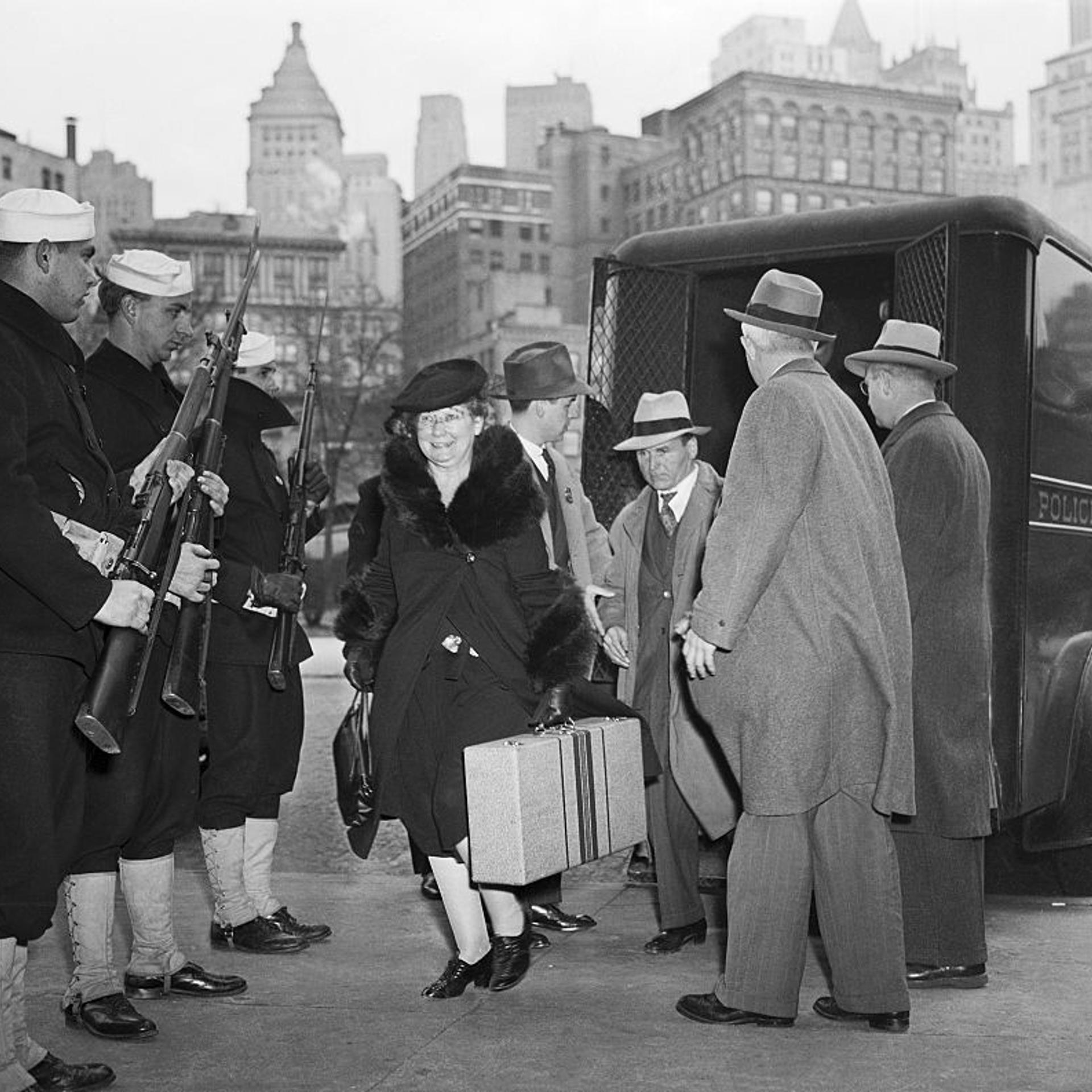 Coast Guardsmen stand guard as illegal migrants arrested by police and FBI agents, and are escorted out of a police van at the barge office in New York City on Dec. 9, 1941. They were later transferred to the immigration detention center on Ellis Island.