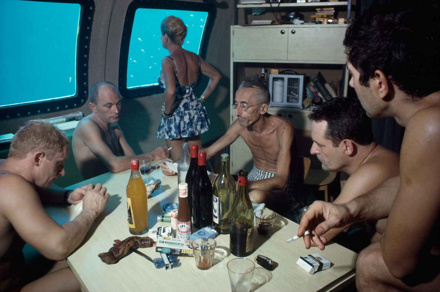 The Cousteaus and their crew relax in a submersible after work during the Conshelf II Expedition.