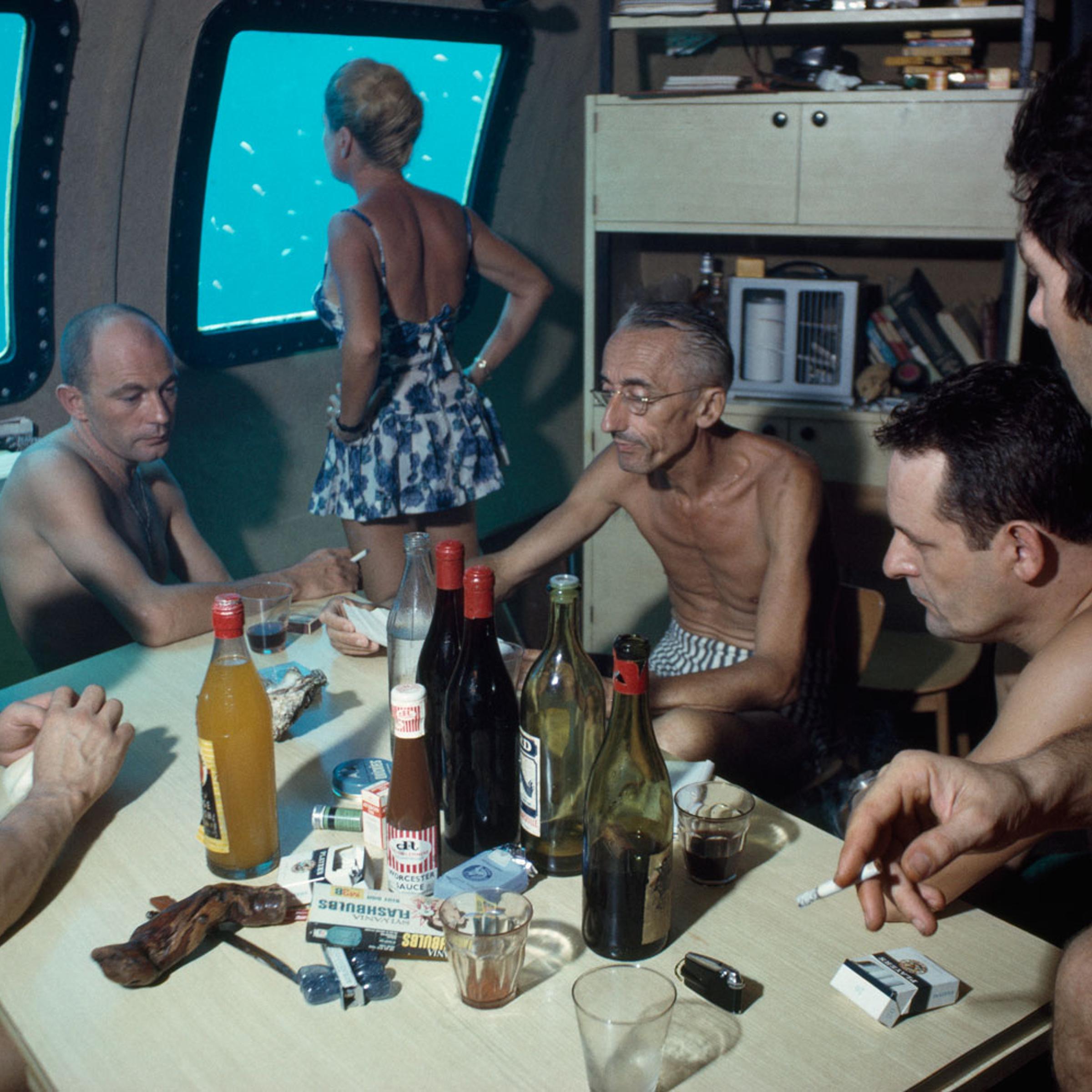 The Cousteaus and their crew relax in a submersible after work during the Conshelf II Expedition.