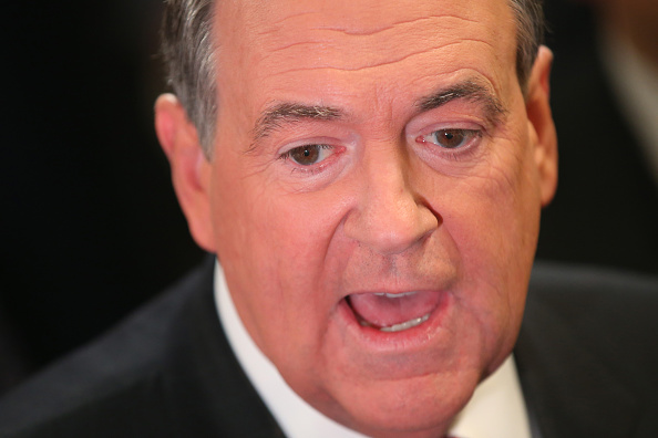 Republican presidential candidate Mike Huckabee talks to reporters in the spin room after the first part of the Fox Business Network Republican presidential debate at the North Charleston Coliseum and Performing Arts Center on January 14, 2016 in North C