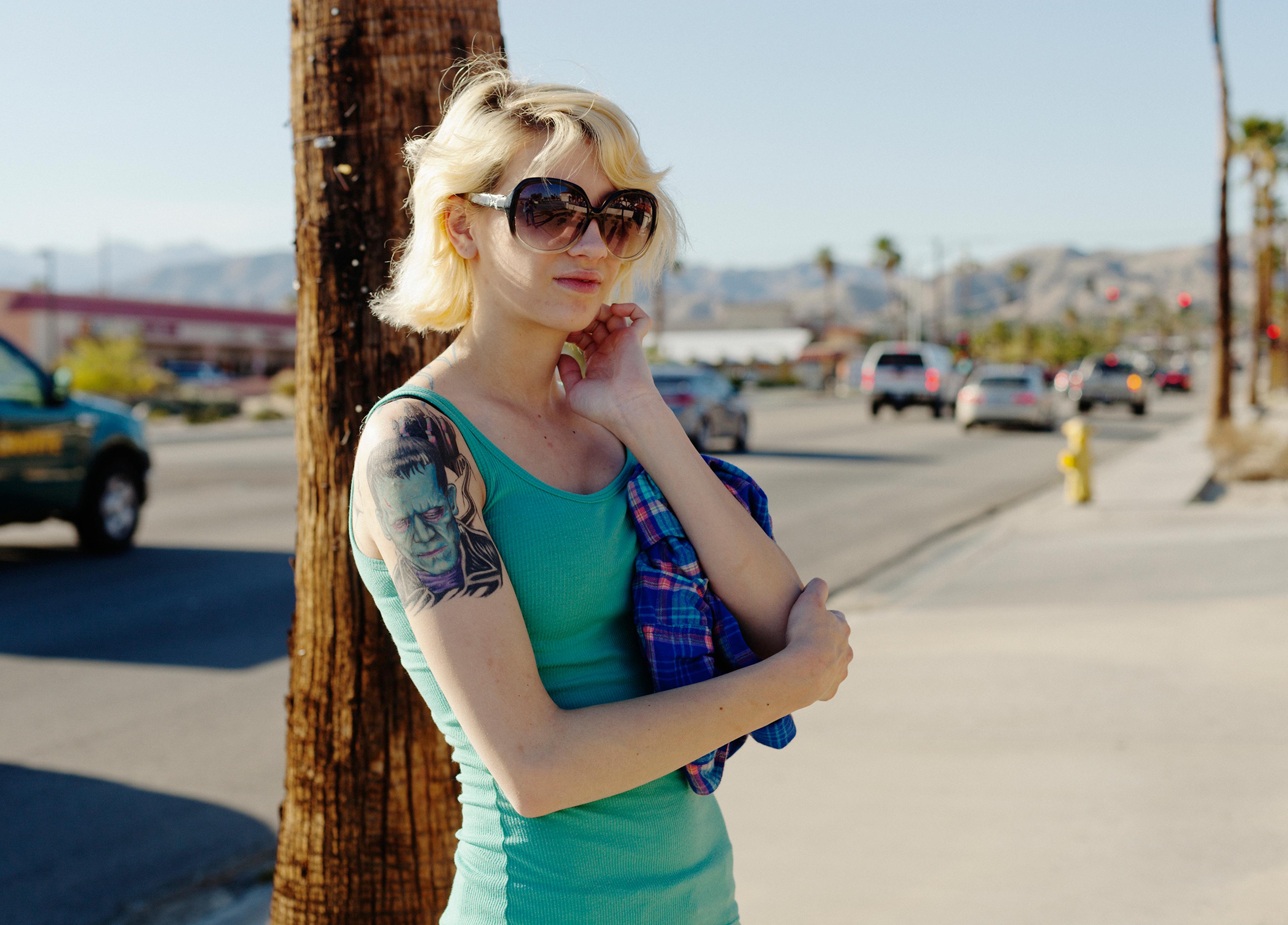San Andreas Fault, California: Desert Hot Springs. Not many people are seen on the pavement in Desert Hot Springs. After just a few seconds of photographing this girl a car came down the street, the driver shouting at me: Get in your car! The girl angril